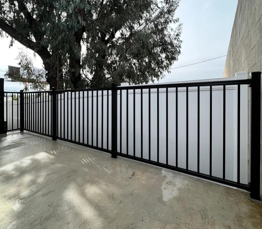 Pool Fence Comparison Vinyl Aluminum Glass: Vinyl vs Aluminum vs Glass 2 Black aluminum pool fence with decorative spear-top pickets installed at an Orange County home