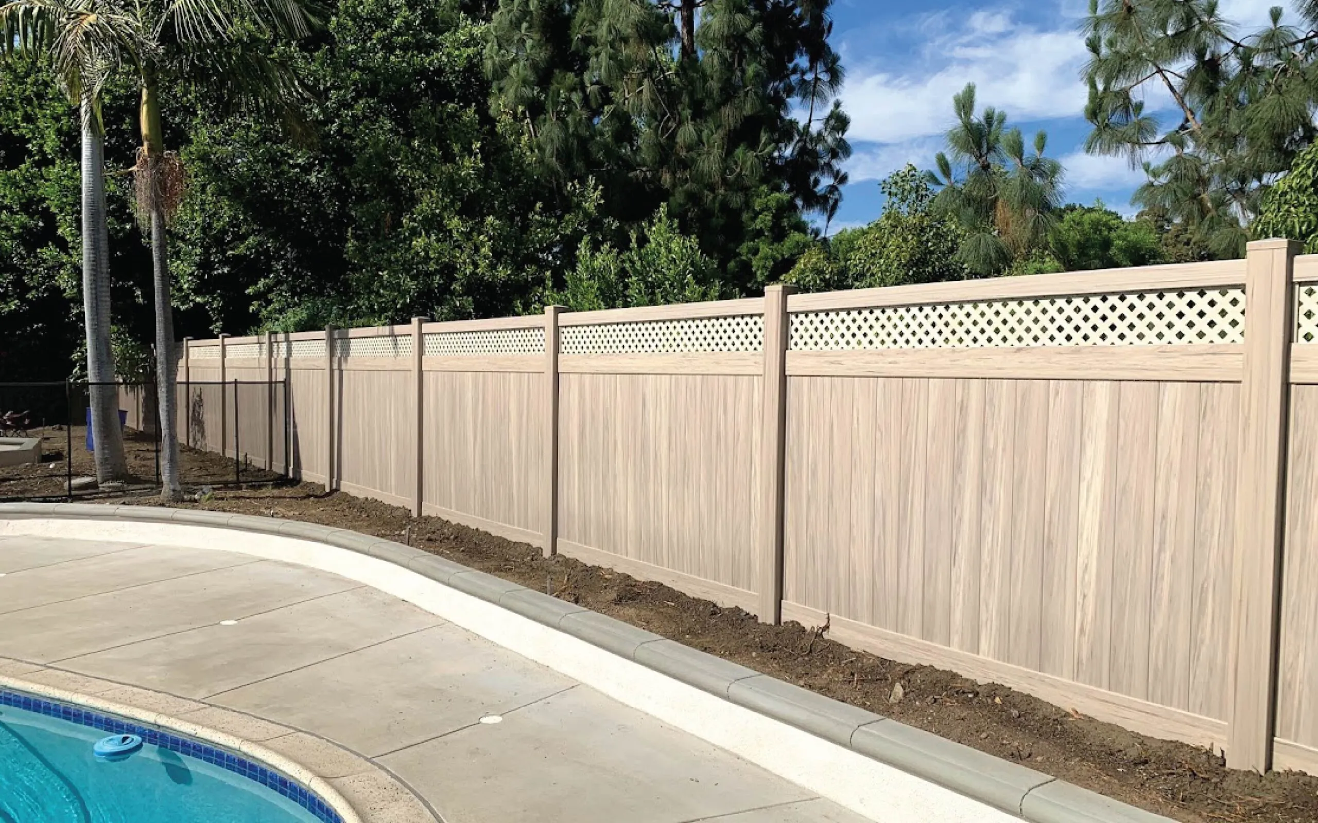 Pool Fence Comparison Vinyl Aluminum Glass: Vinyl vs Aluminum vs Glass 1 White vinyl pool fence installation in an Orange County backyard with privacy panels and secure gate