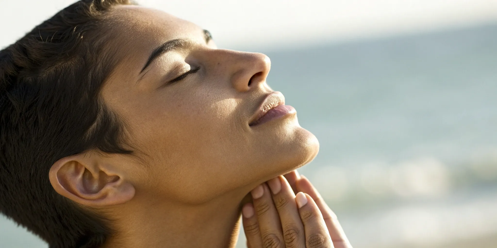 A person touching their jaw, relieved after a before and after chiropractic adjustment.