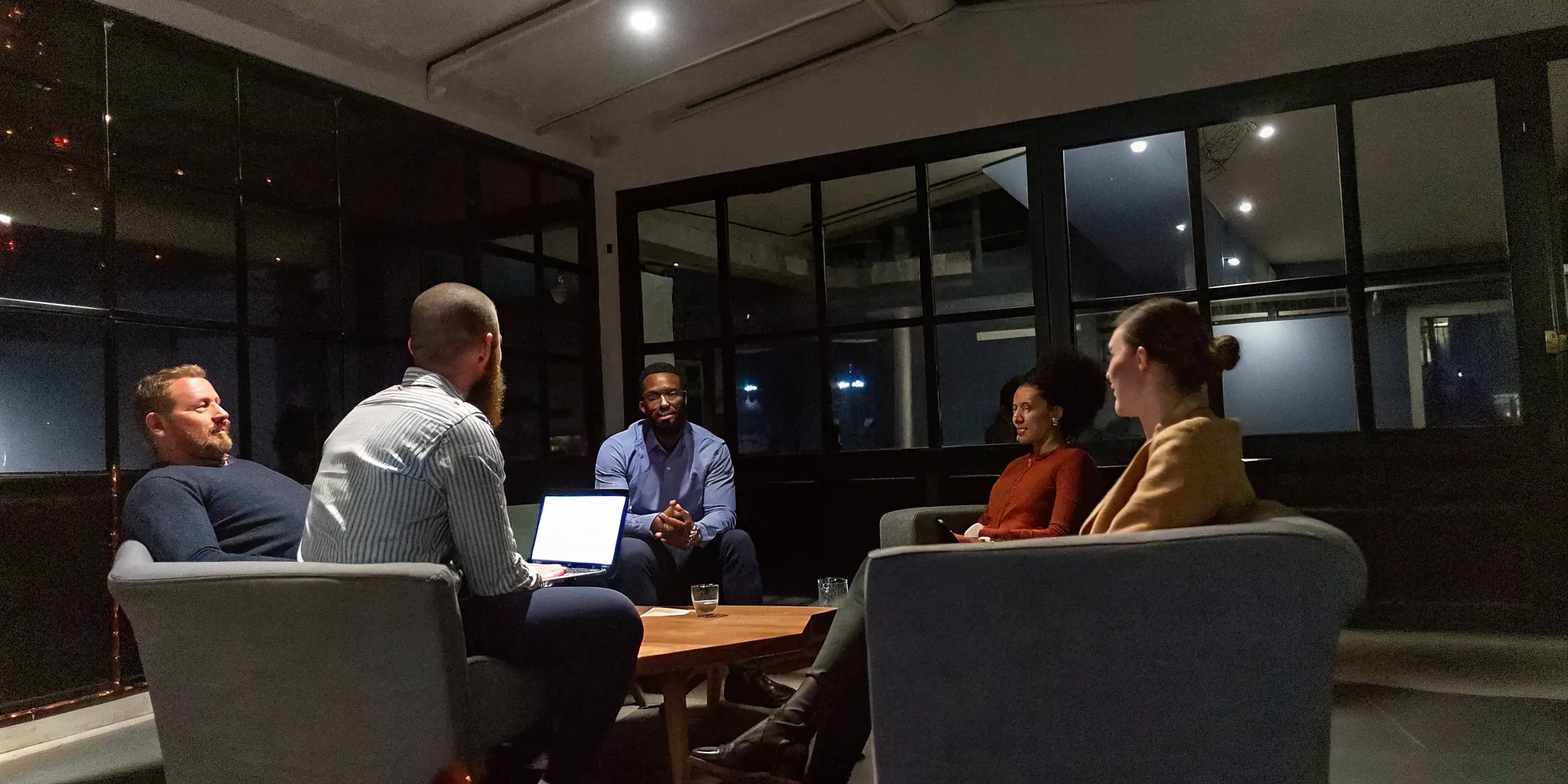 Cross-functional Dallas team conducting a structured leadership debrief session
