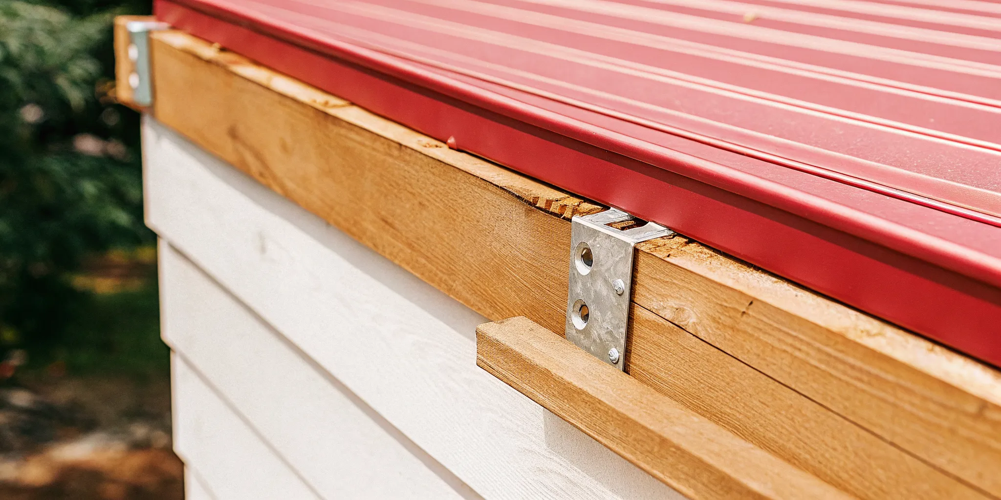 Layered deck ledger flashing behind an attached deck frame