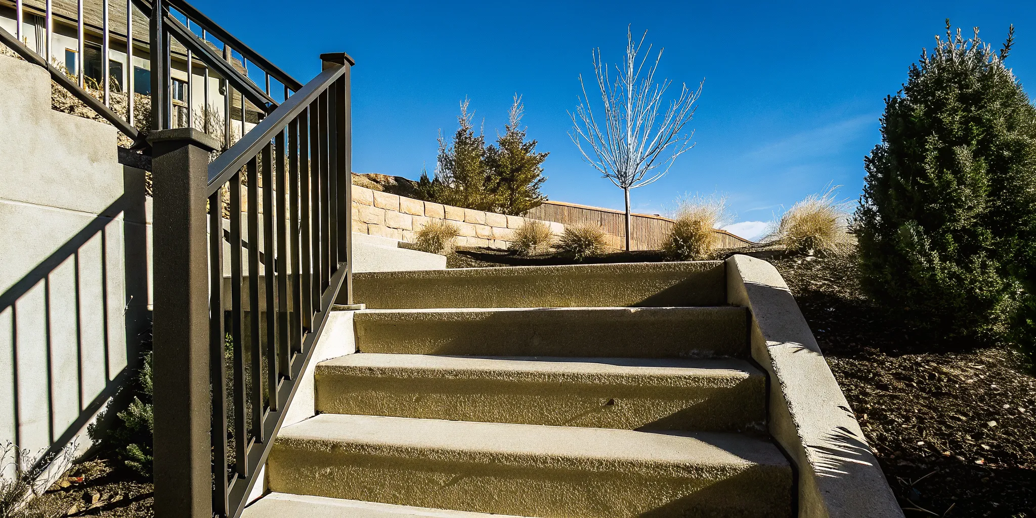 Concrete and masonry outdoor stair materials with textured treads and railing