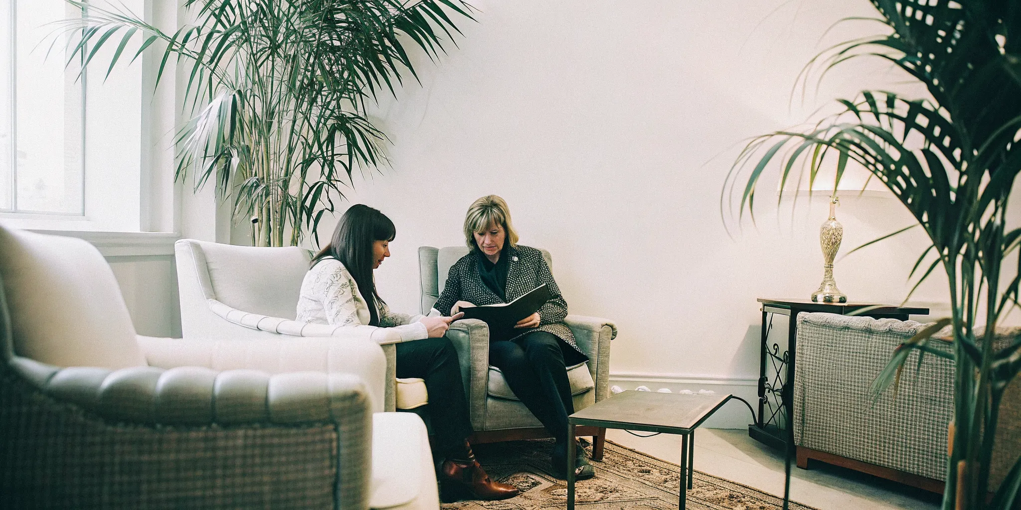 A concierge doctor in Boca Raton guiding a patient through a personalized concierge health plan in a premium medical office