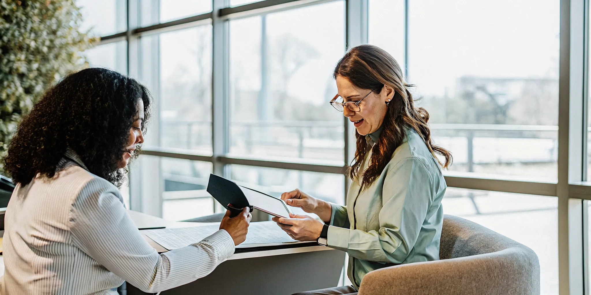 Corporate passport and visa services staff reviewing employee travel documents in a bright office