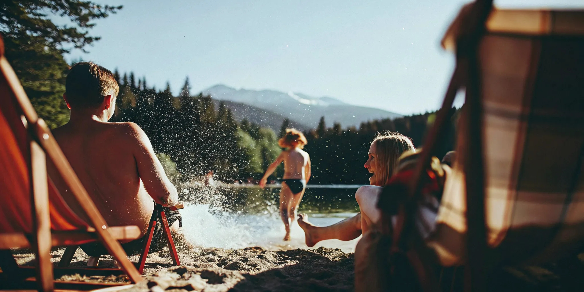 Family enjoying a sunny afternoon at Alta Lake in Whistler with mountains in the background