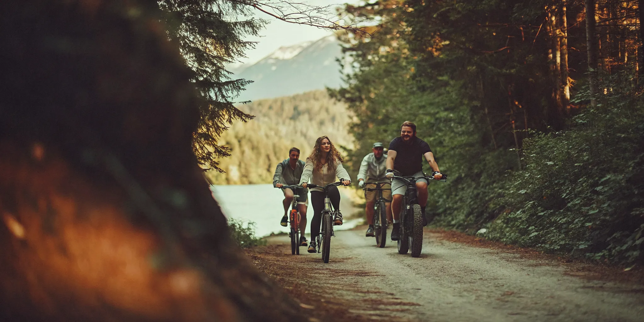 Guided group riding fat tire eBikes along a forested Whistler valley trail