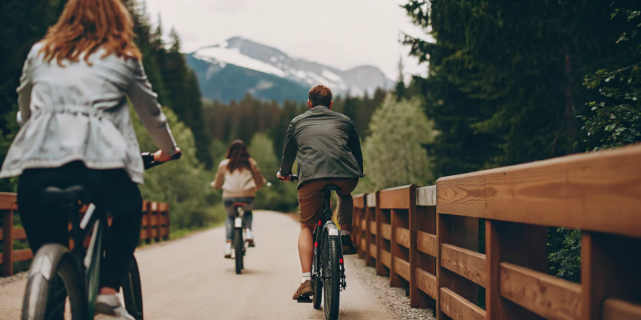 Mixed-fitness group riding fat tire eBikes together on a scenic Whistler valley trail