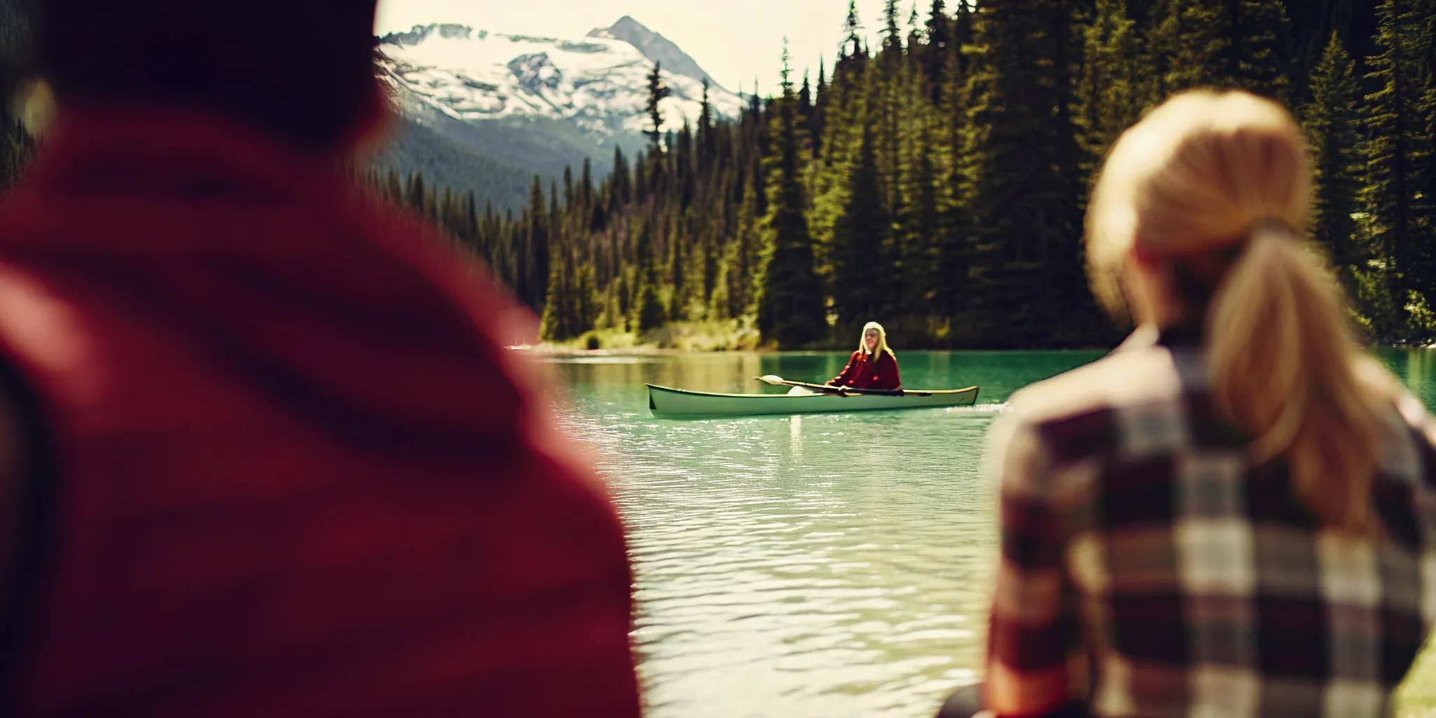 Calm glacier-fed alpine lake in Whistler with a paddler and mountain views