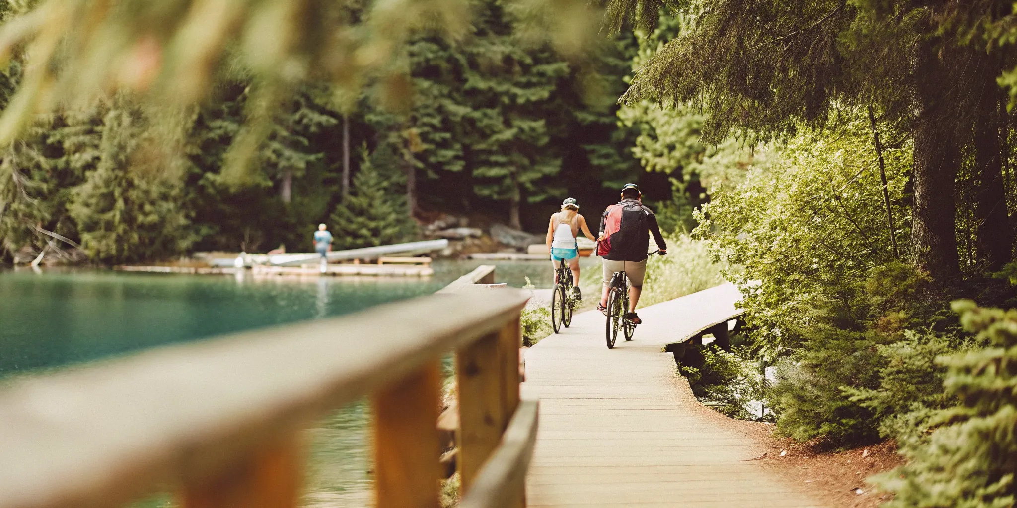Scenic Whistler valley with glacier-fed lake, old-growth cedar forest, and paved cycling trail