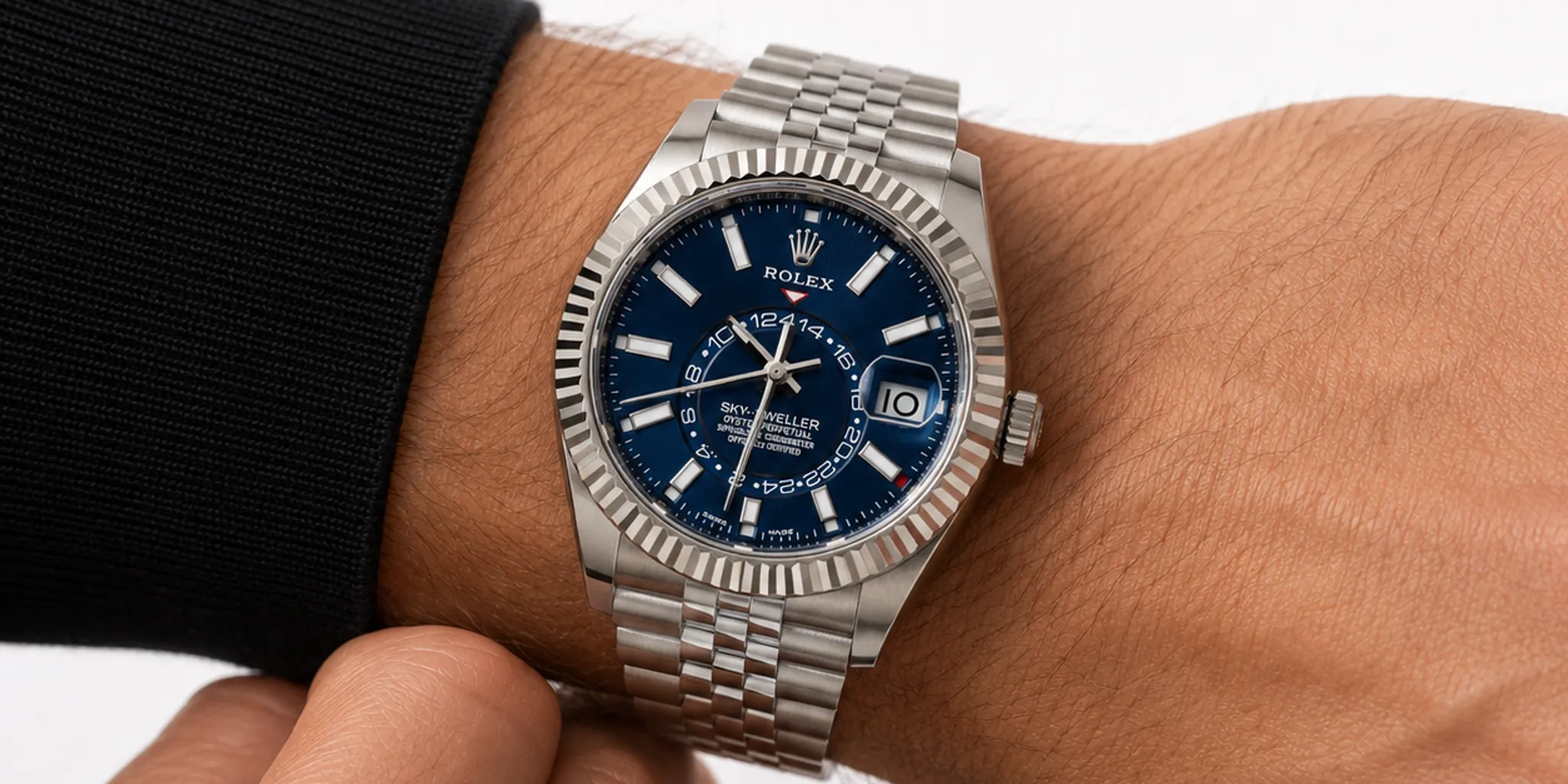 Buyer viewing a pre-owned luxury watch with a jeweler