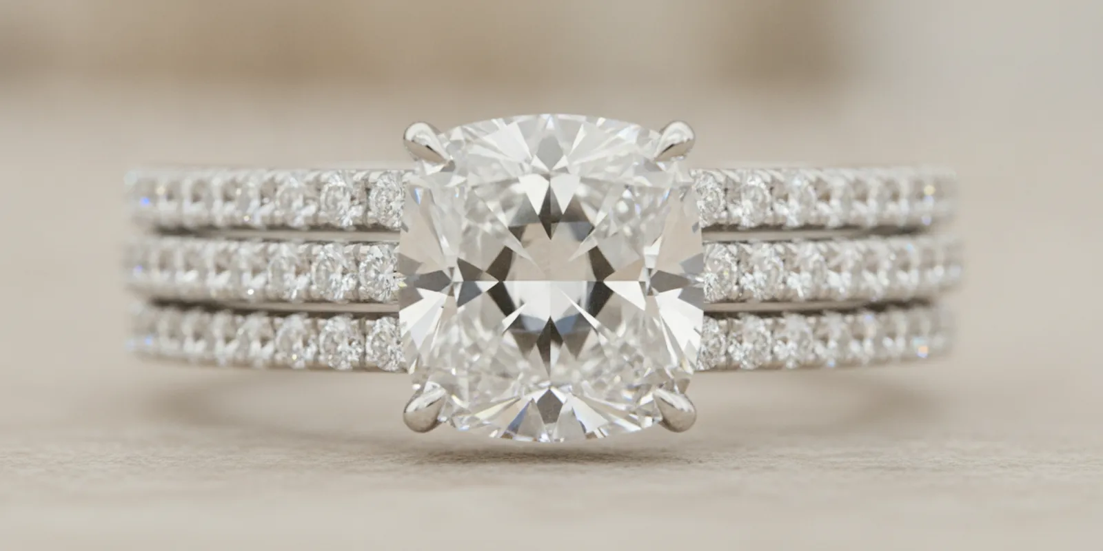 Diamond pavé engagement ring viewed from above and at an angle on a neutral jewelry display