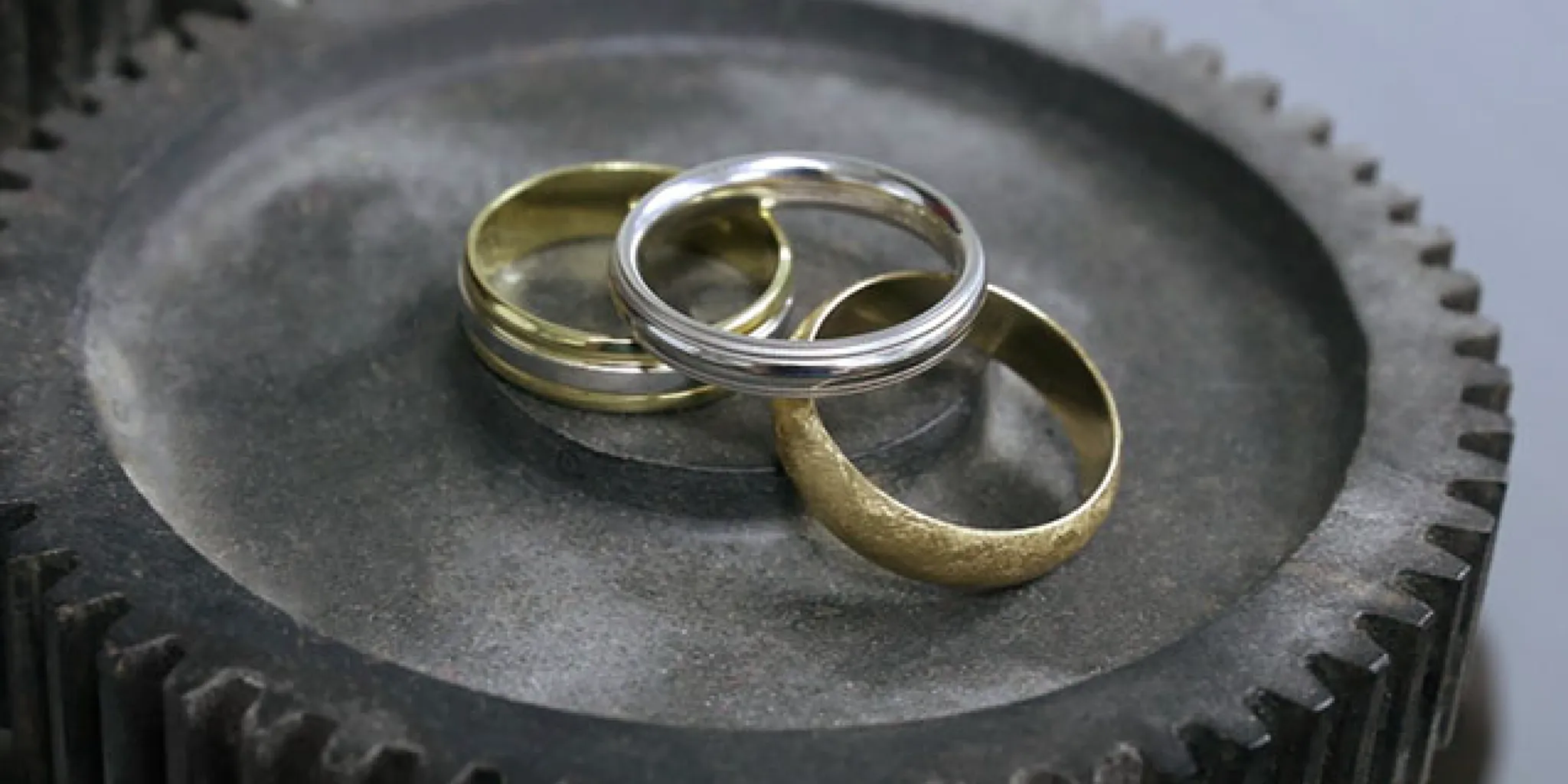 Close view of a man's hand wearing a simple engagement ring
