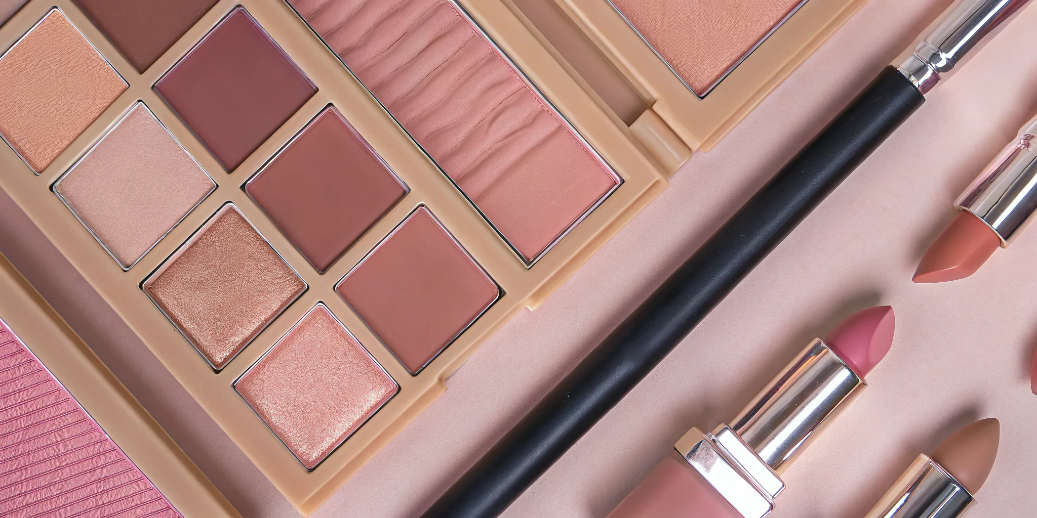 Elegant display of nude lip liner, lipstick, and gloss products arranged on a white surface
