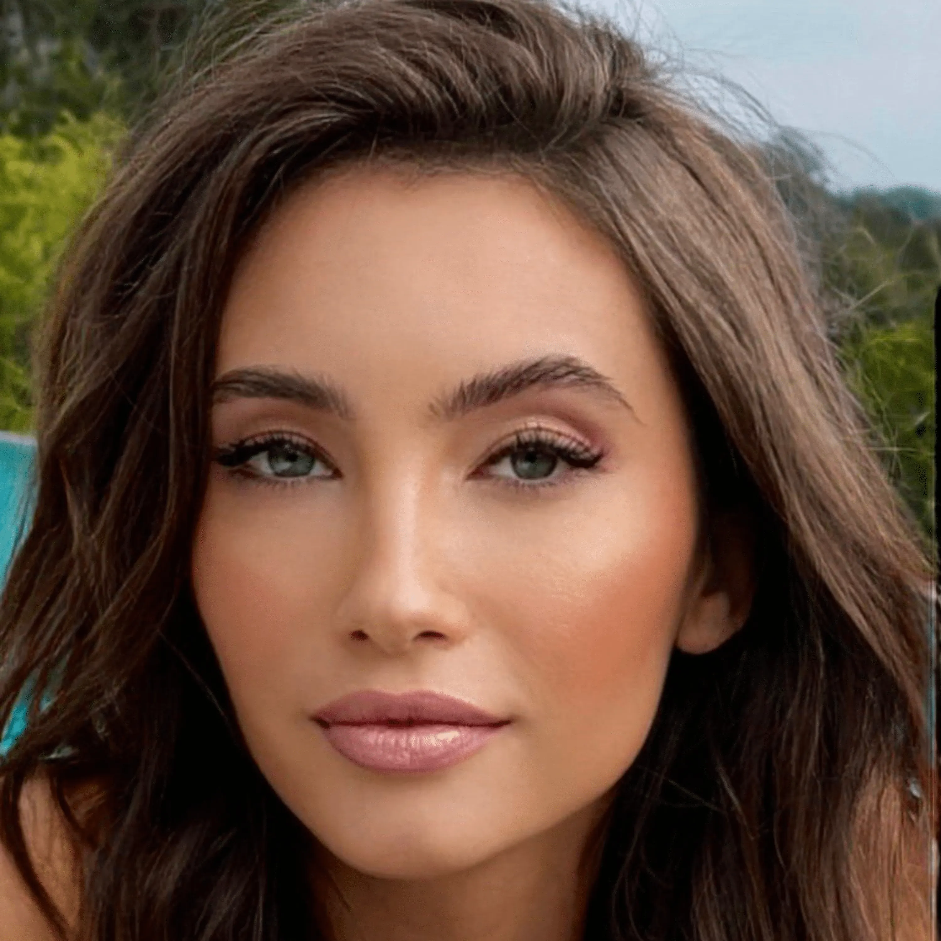 Model wearing coordinated nude lipstick and natural makeup