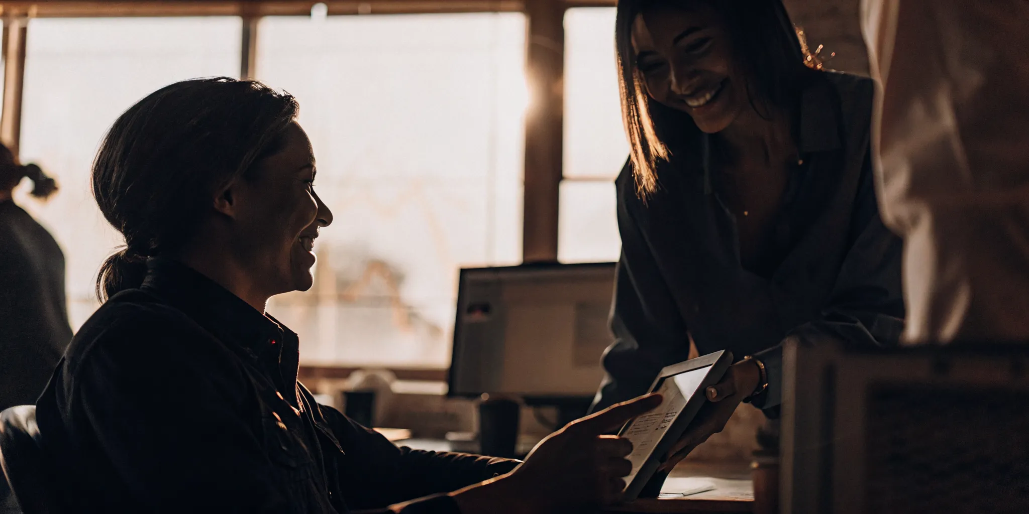 Medical practice administrator and accountant reviewing financial records together in a bright clinic office