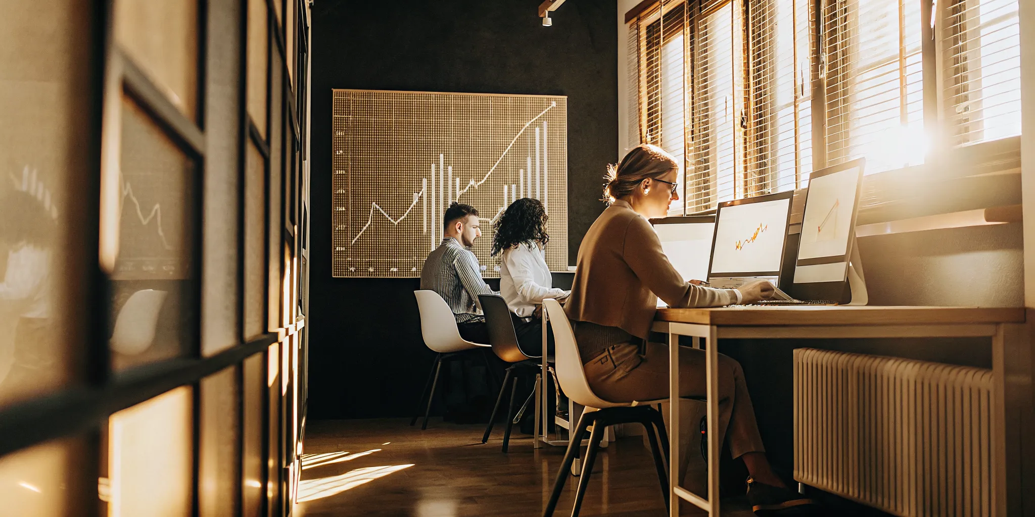 Professional accounting and finance team analyzing growth charts and financial reports in a modern office