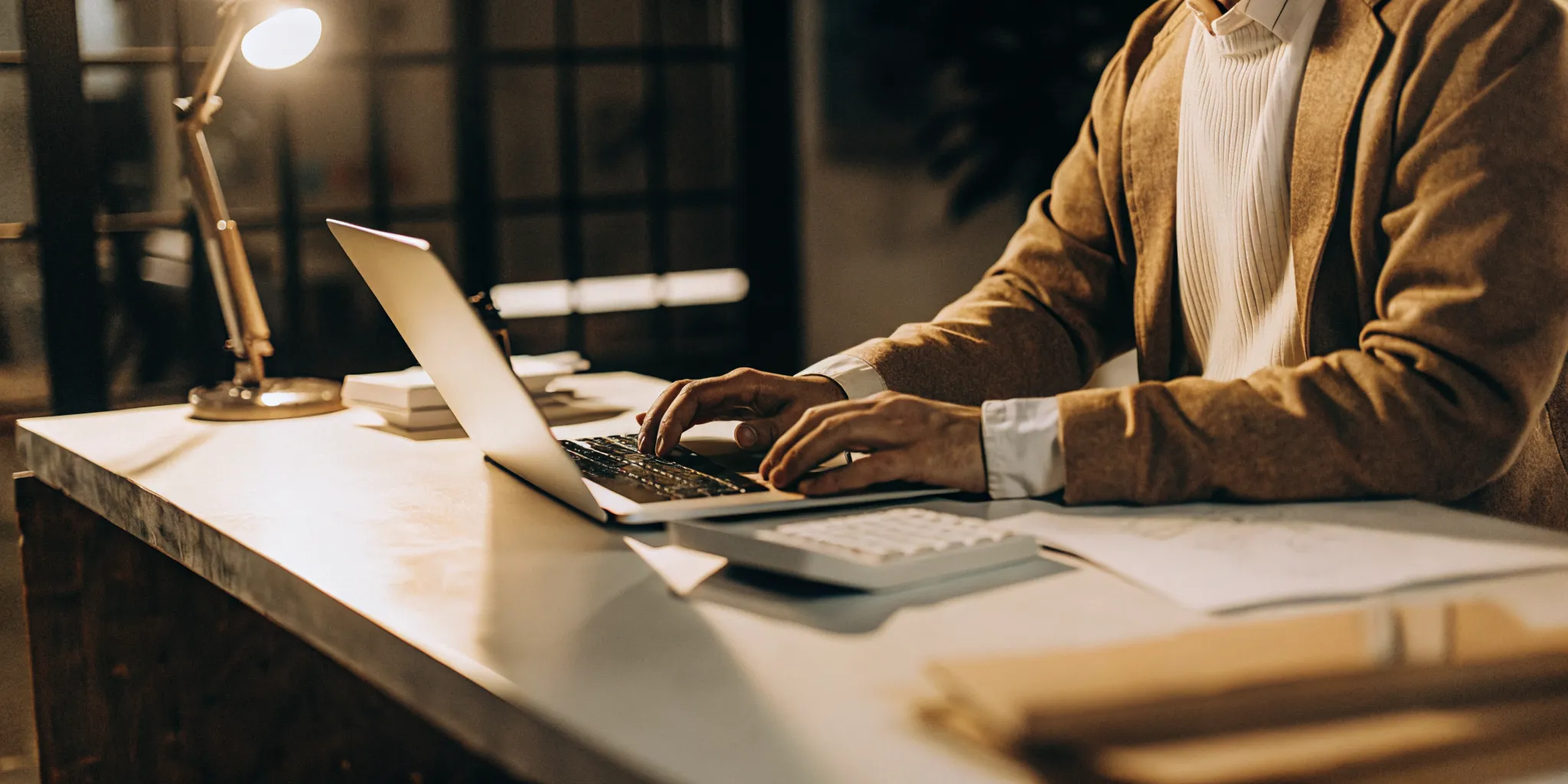 LLC owner working from a dedicated home office workspace with tax documents and laptop