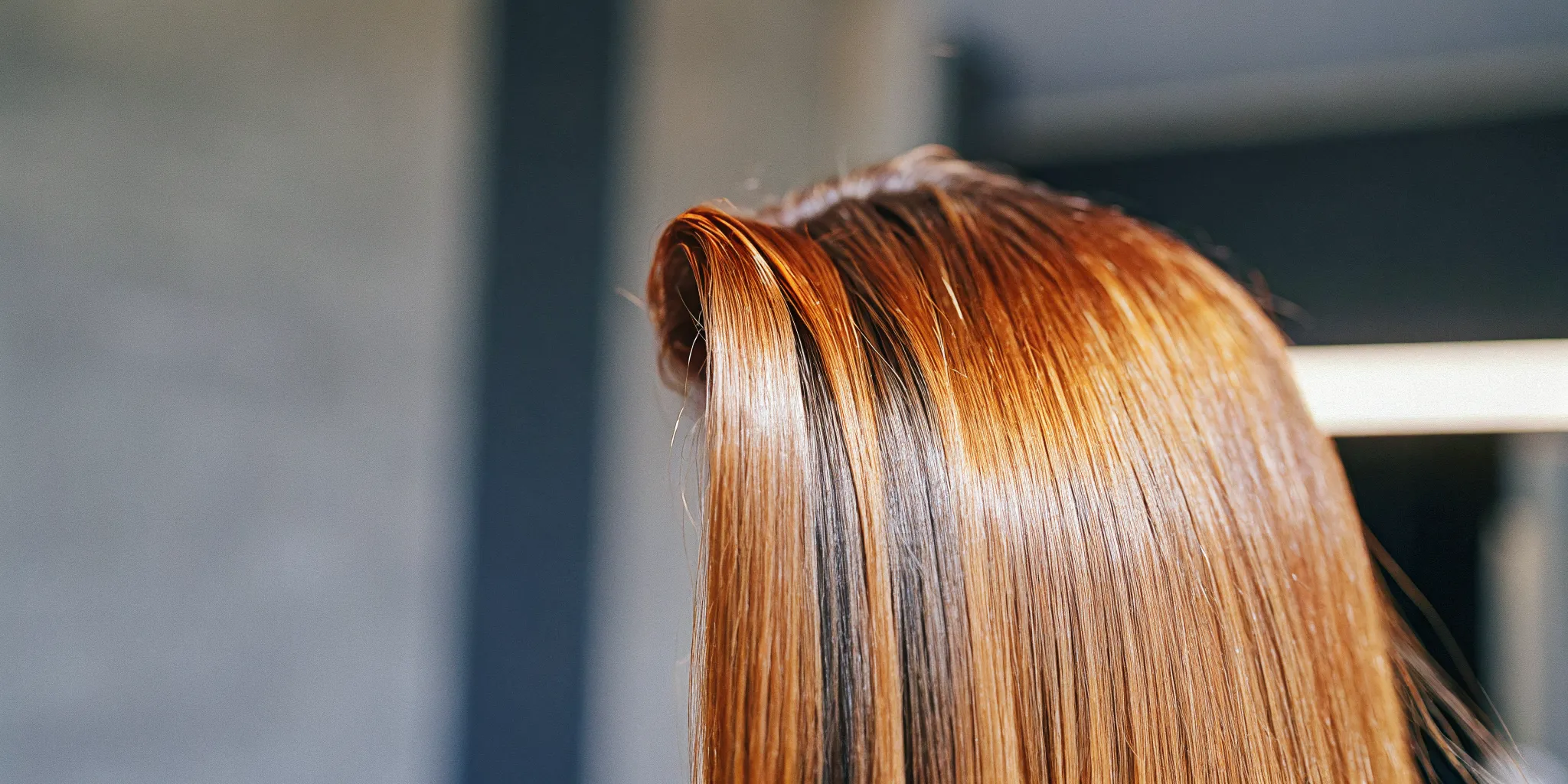 Close-up of glossy healthy color-treated hair with smooth cuticle to prevent hair dye from fading