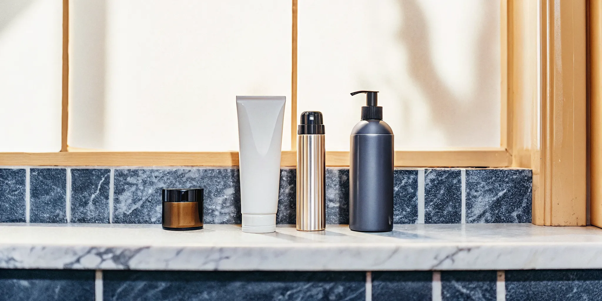 Weekly maintenance routine for red hair with deep conditioner, sulfate-free shampoo, and dry shampoo arranged on a marble vanity