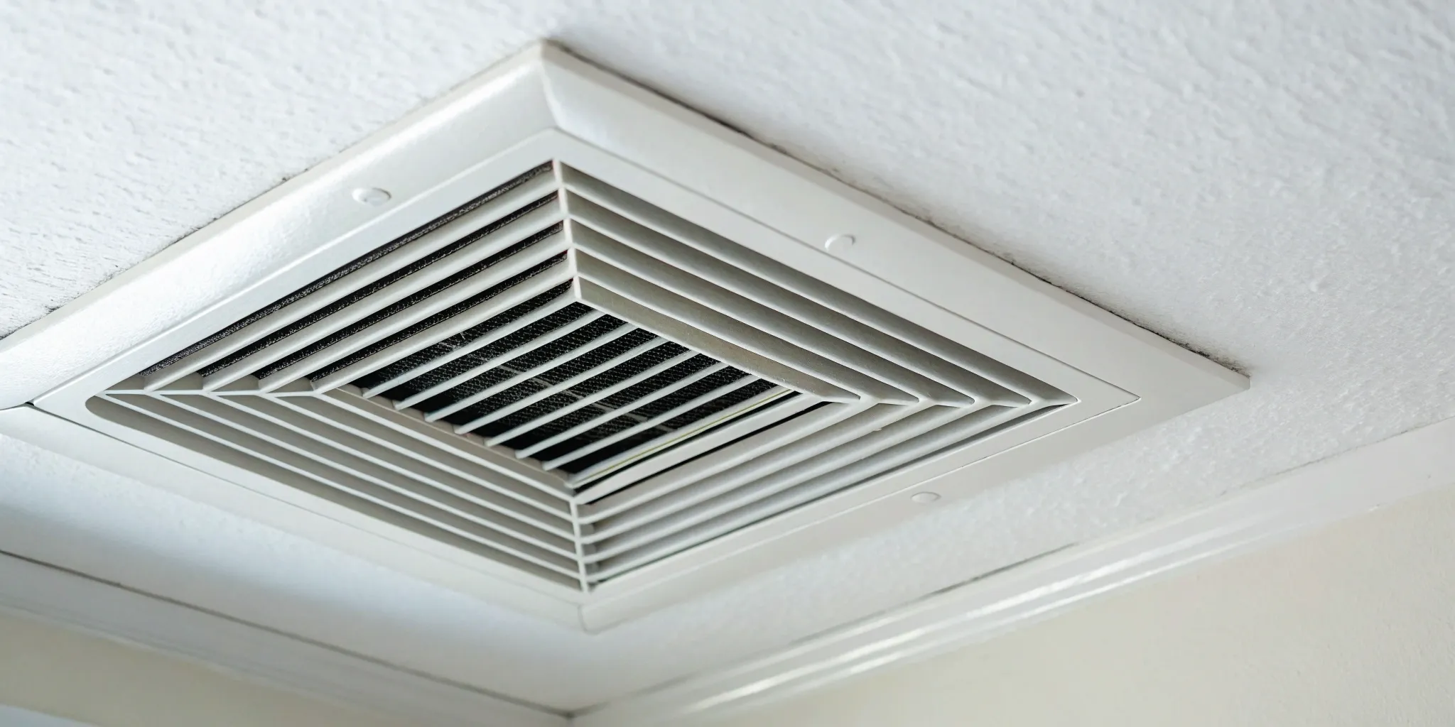 Dusty air duct vent showing why you should know how often to clean air ducts.