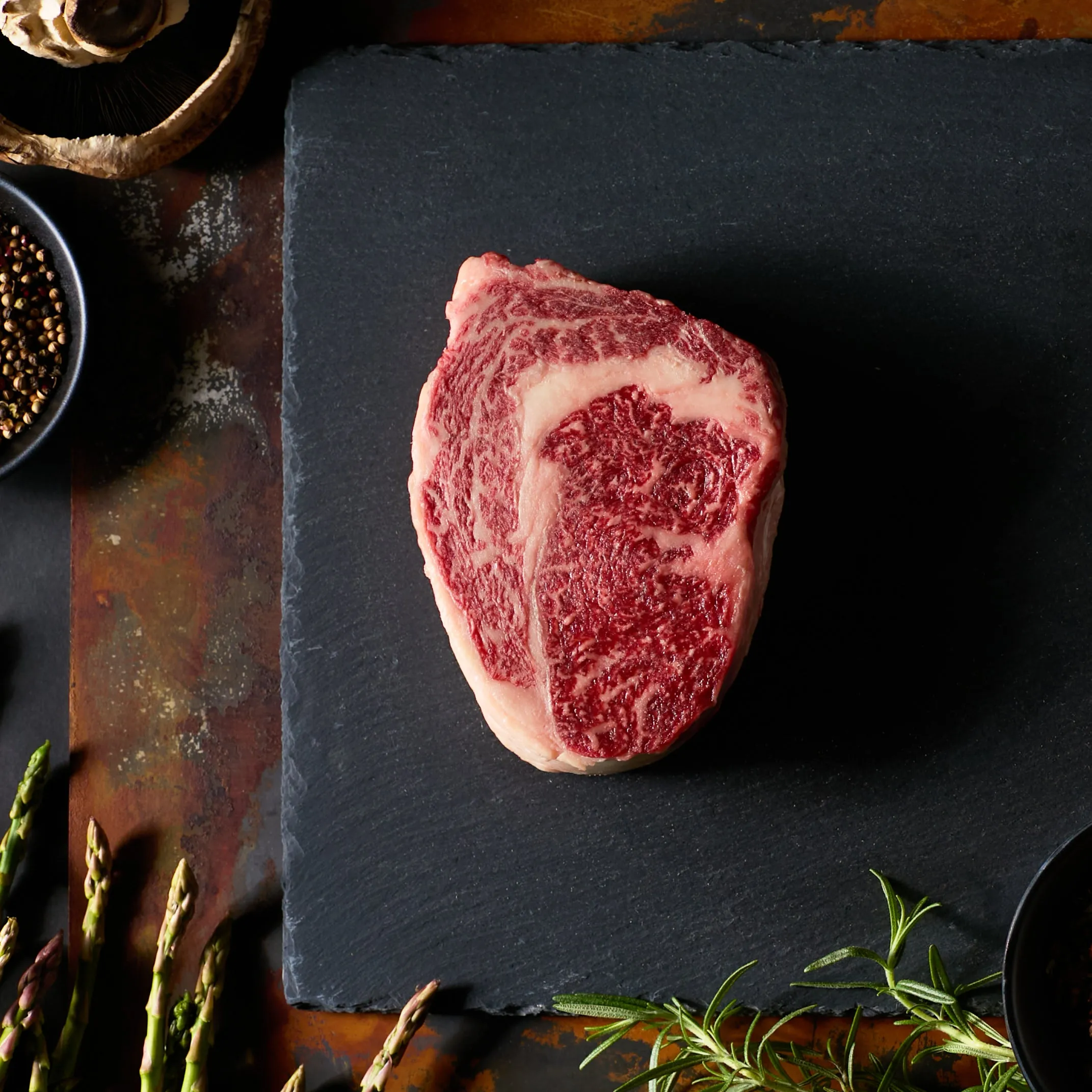 Raw Wagyu ribeye showing fine marbling in a Wagyu vs Angus comparison