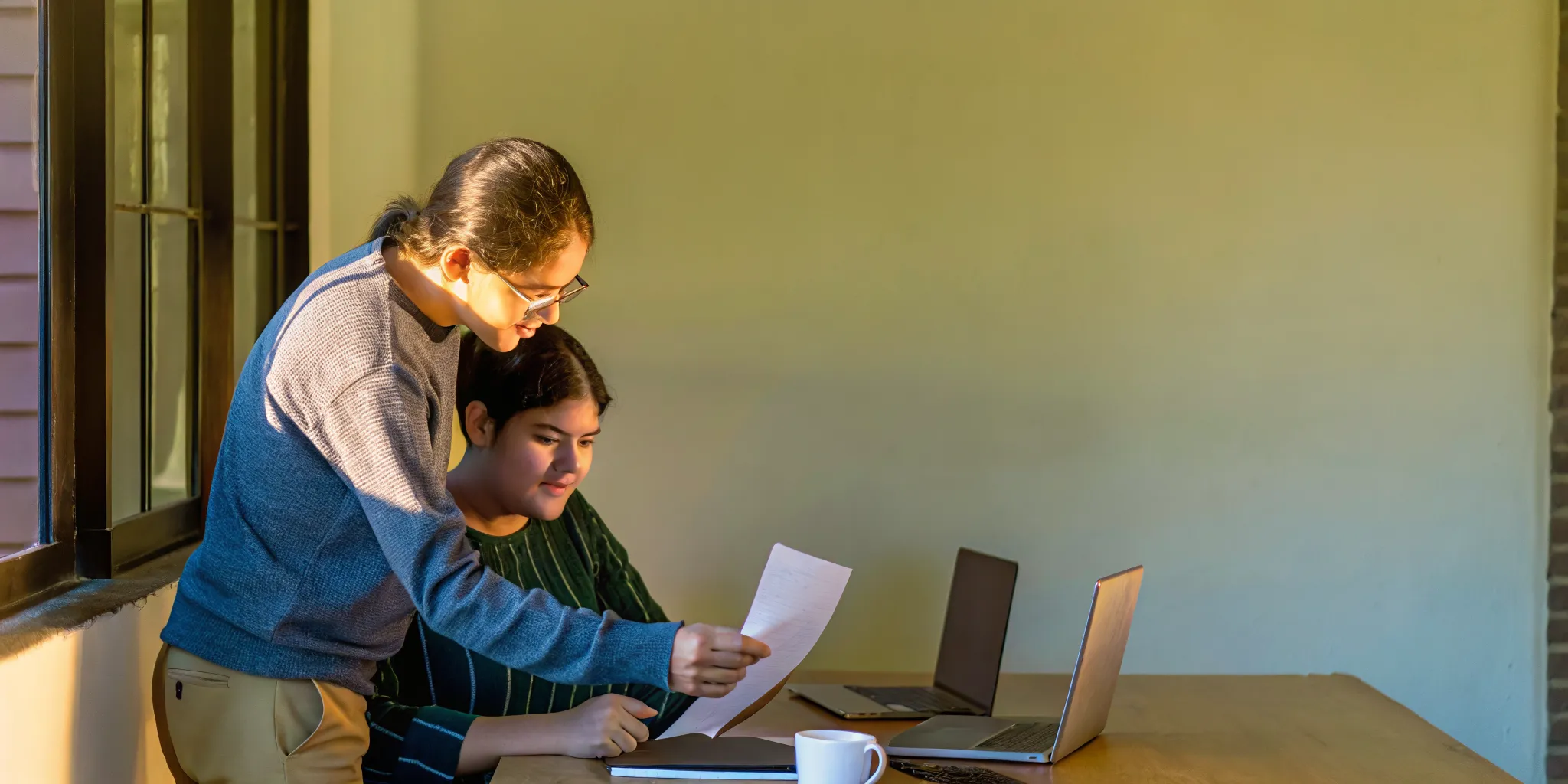 A college essay tutor works with a high school student to refine a personal statement draft