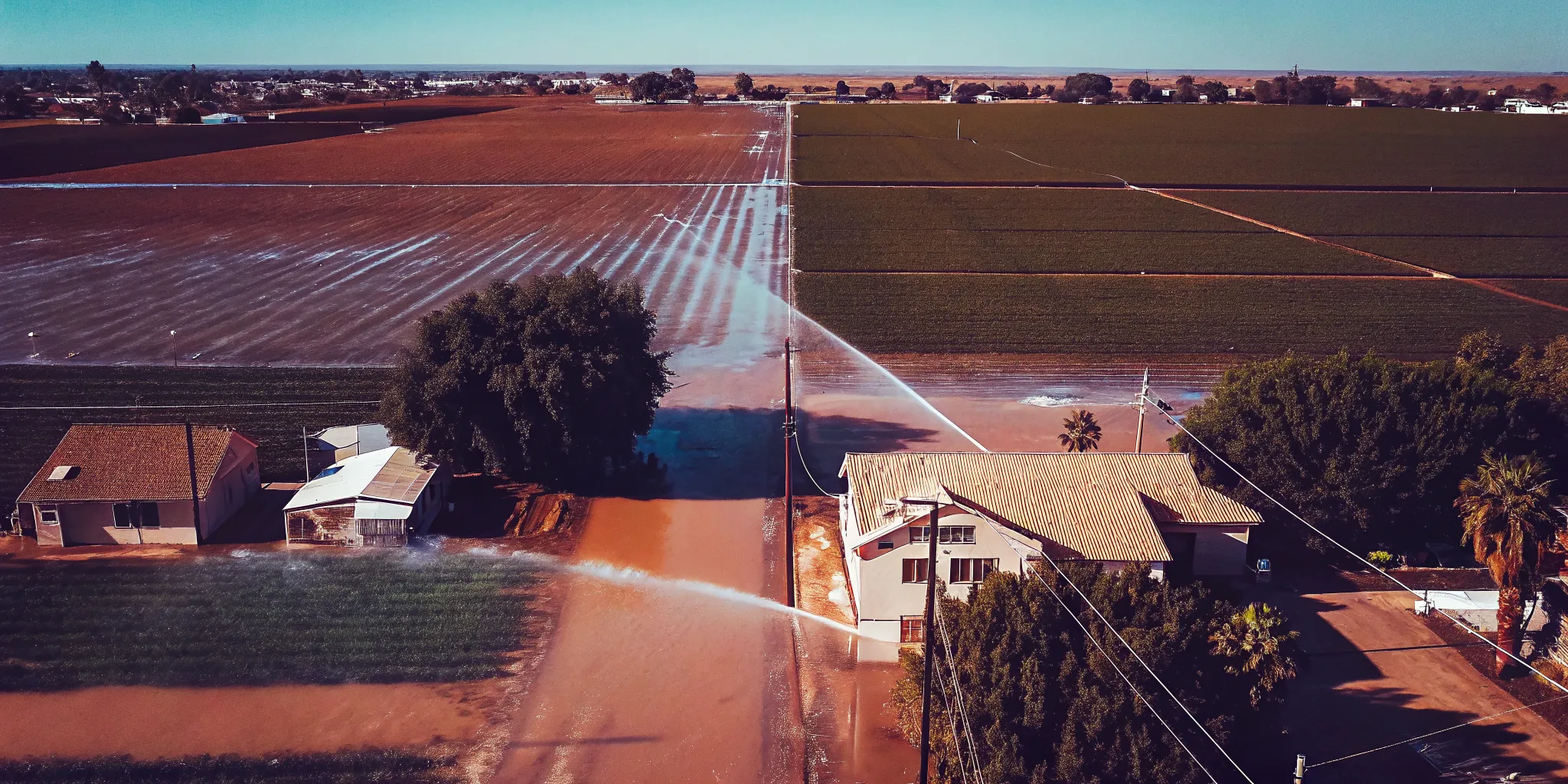 Aerial view of agricultural fields and farmland near Shafter, California showing irrigation systems near residential neighborhoods