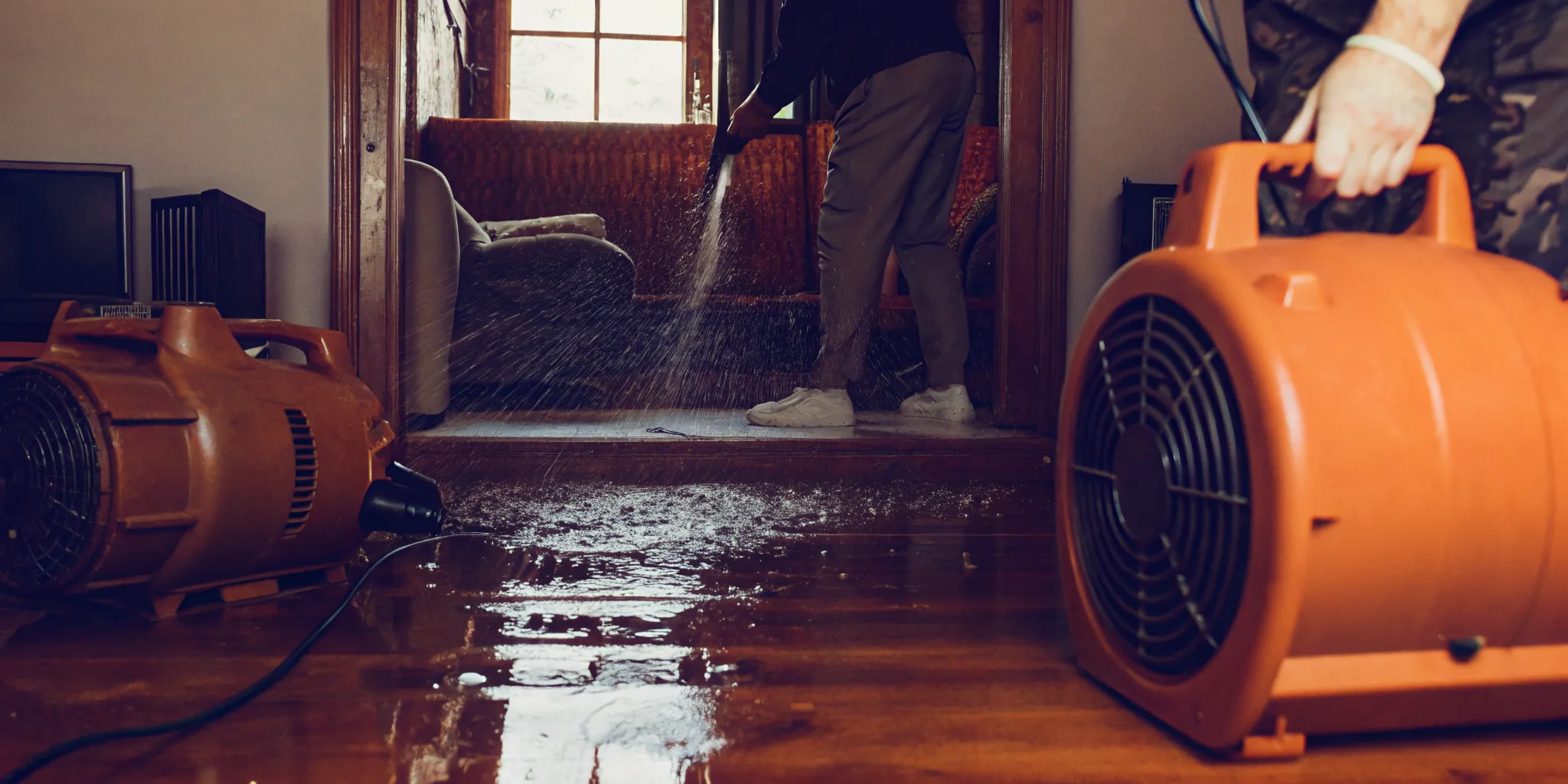 Industrial-grade air movers and dehumidifier drying a water-damaged building in Kern County