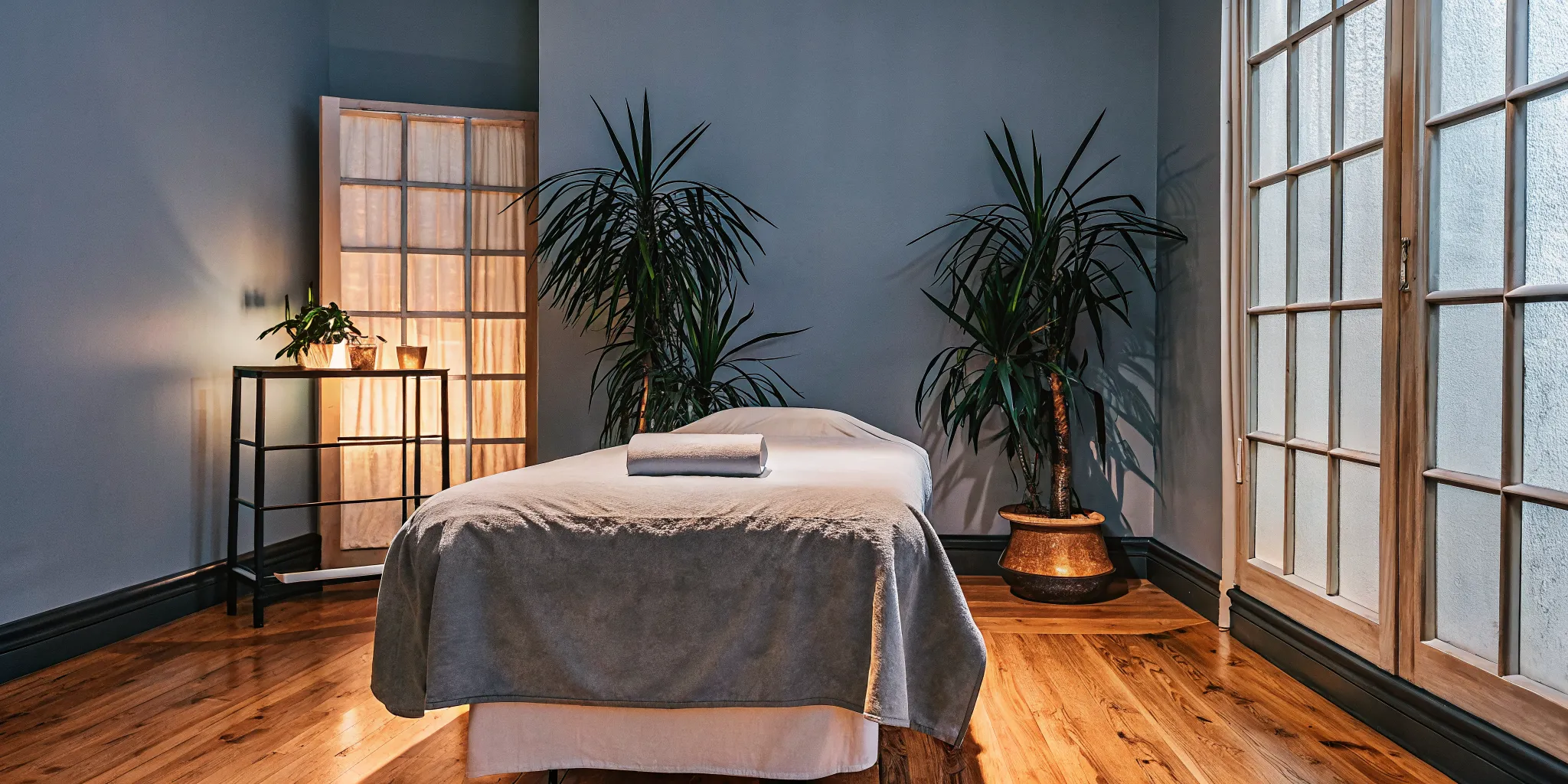 Peaceful massage therapy studio in New Orleans with warm lighting and professional treatment table
