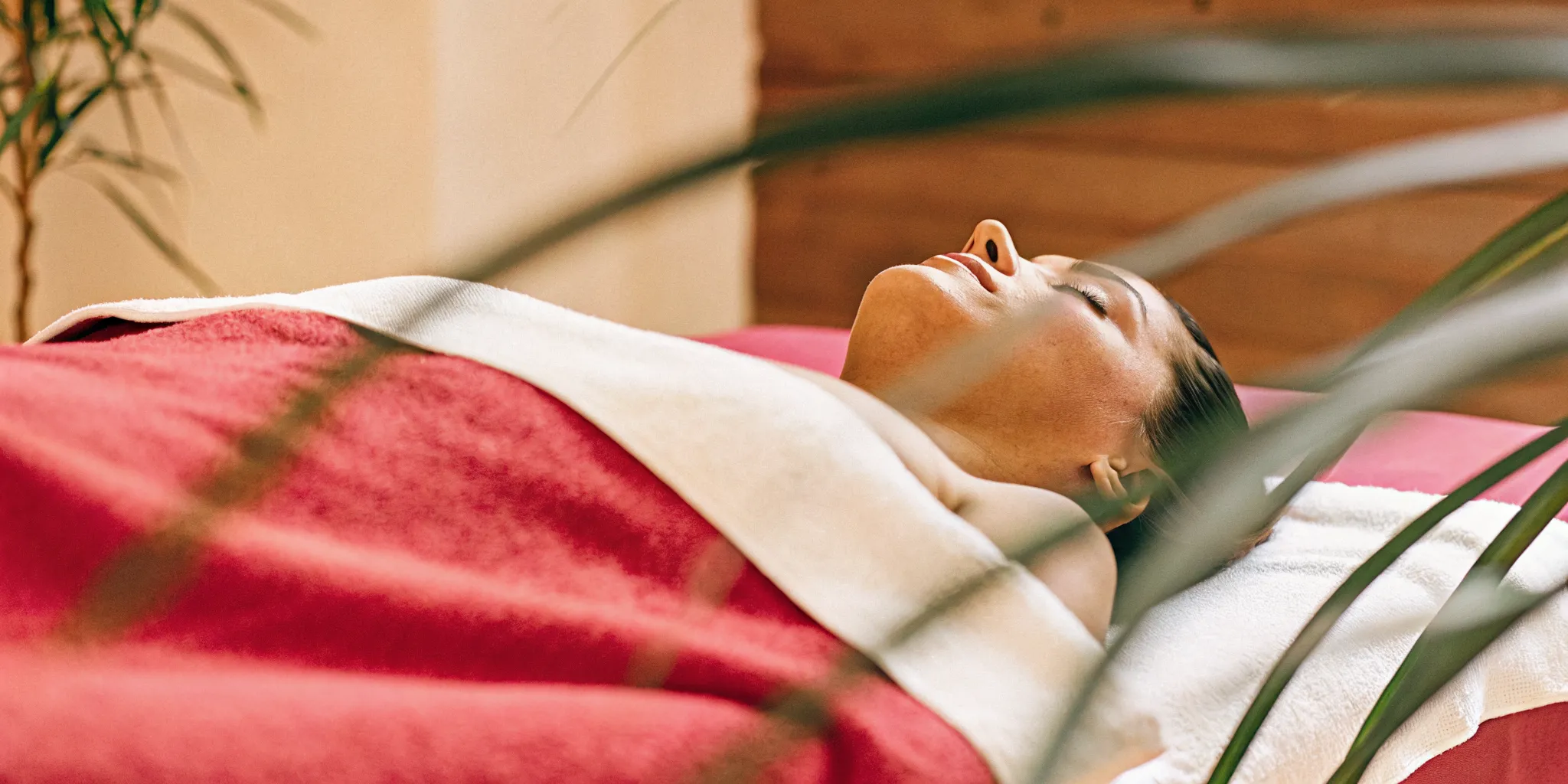 Tranquil client resting in a peaceful, dimly lit NOLA Bliss massage room