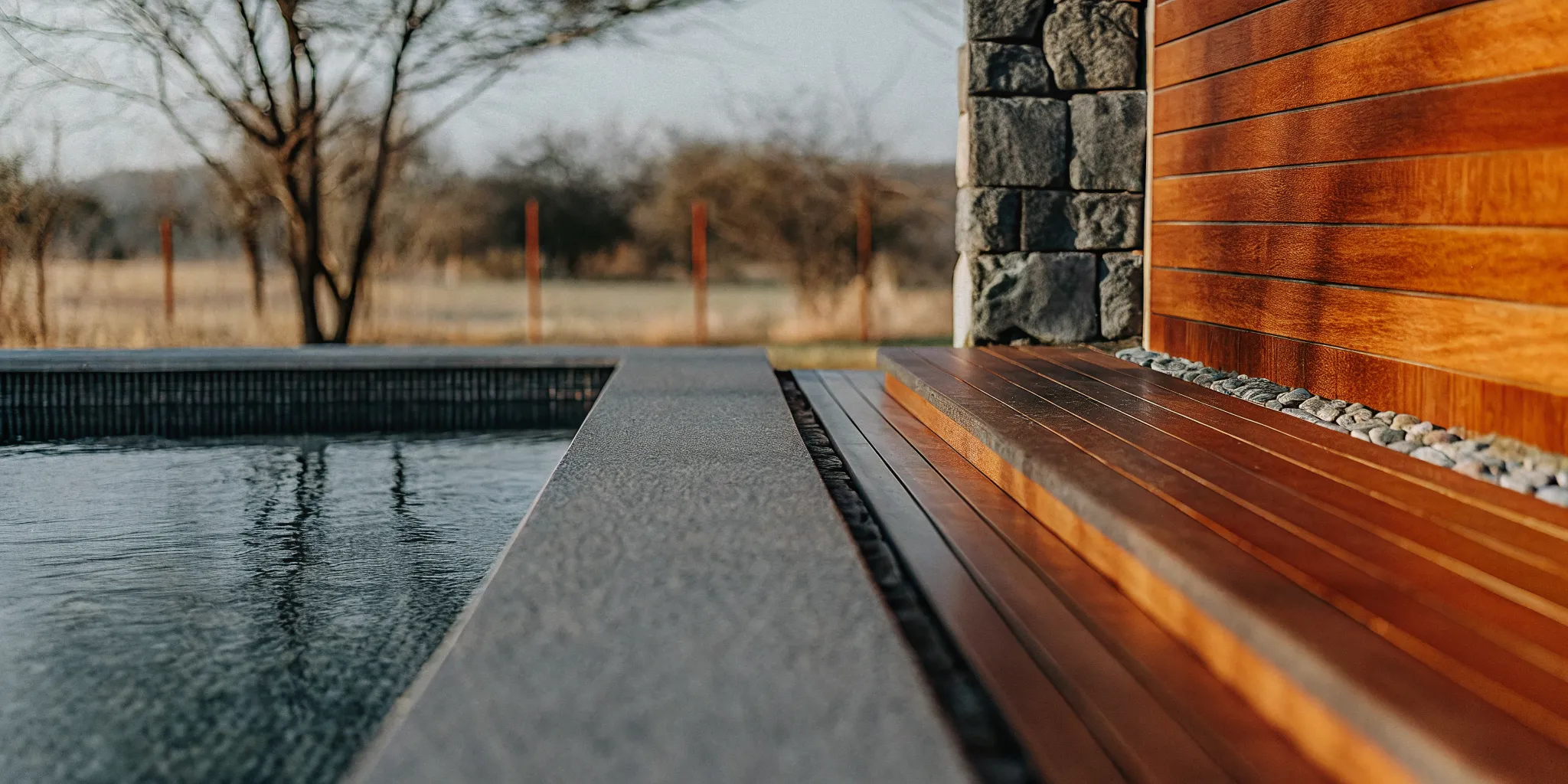 Light blue Hydrazzo pool finish color beside natural stone coping