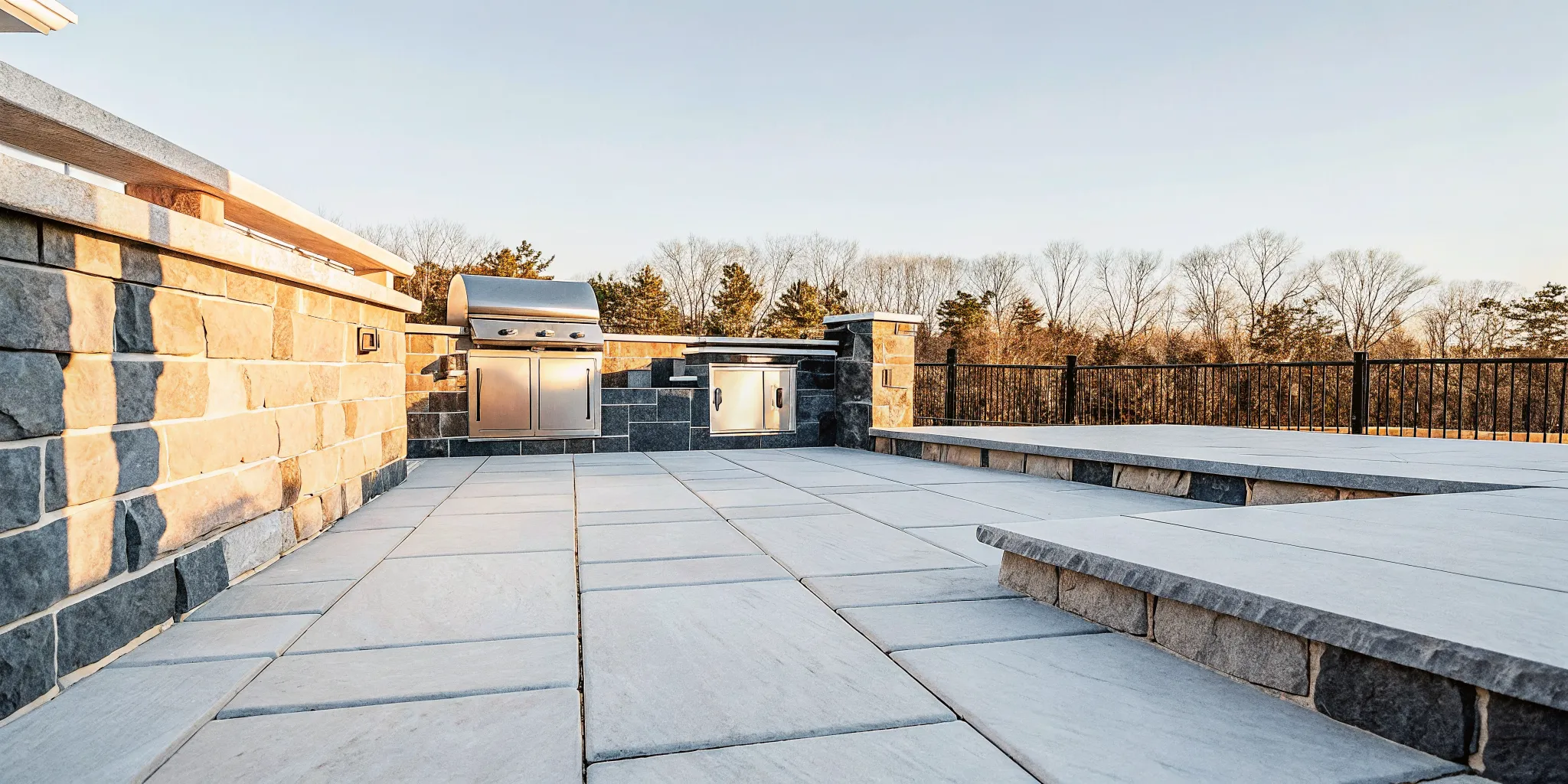 Natural stone patio with Italian-style precision stonework and outdoor kitchen on Long Island