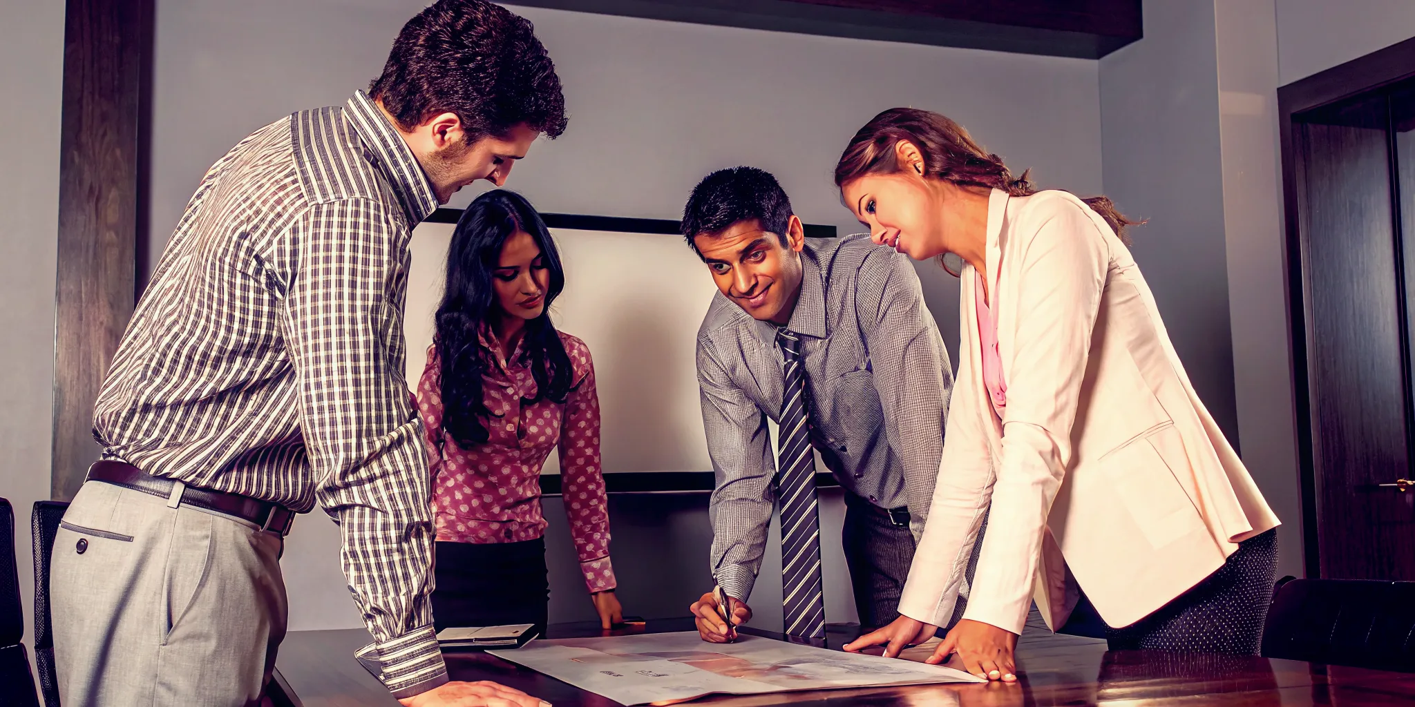 Executive team discussing leadership development ROI and business outcomes