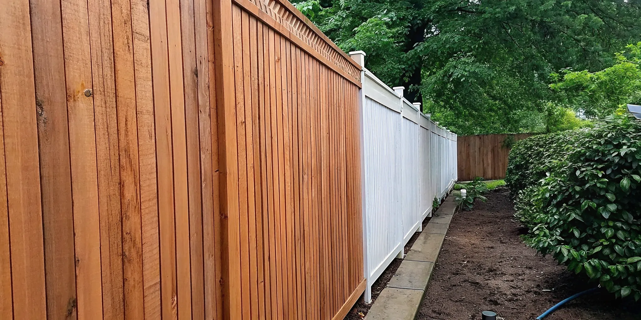 Professionally maintained wood fence bordering a landscaped Long Island residence