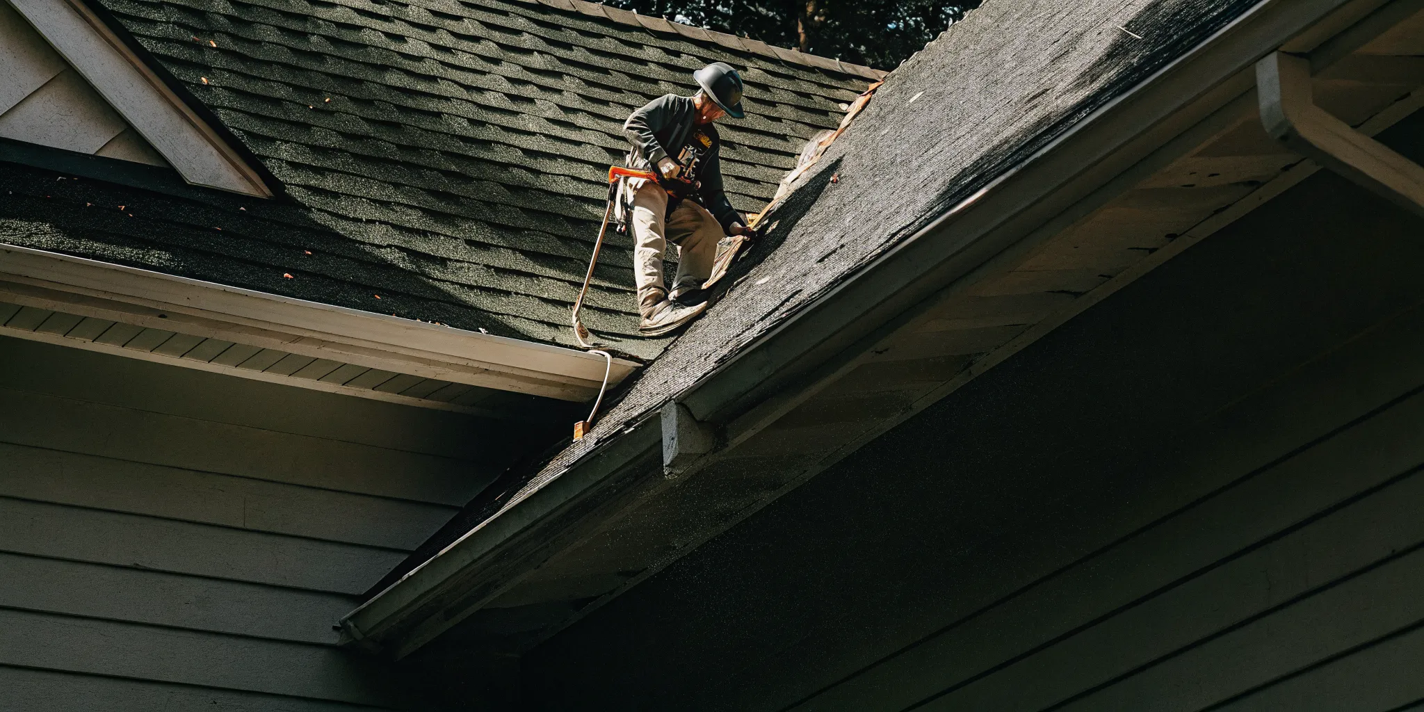 Roofer inspecting Class 4 shingles after a Texas hailstorm