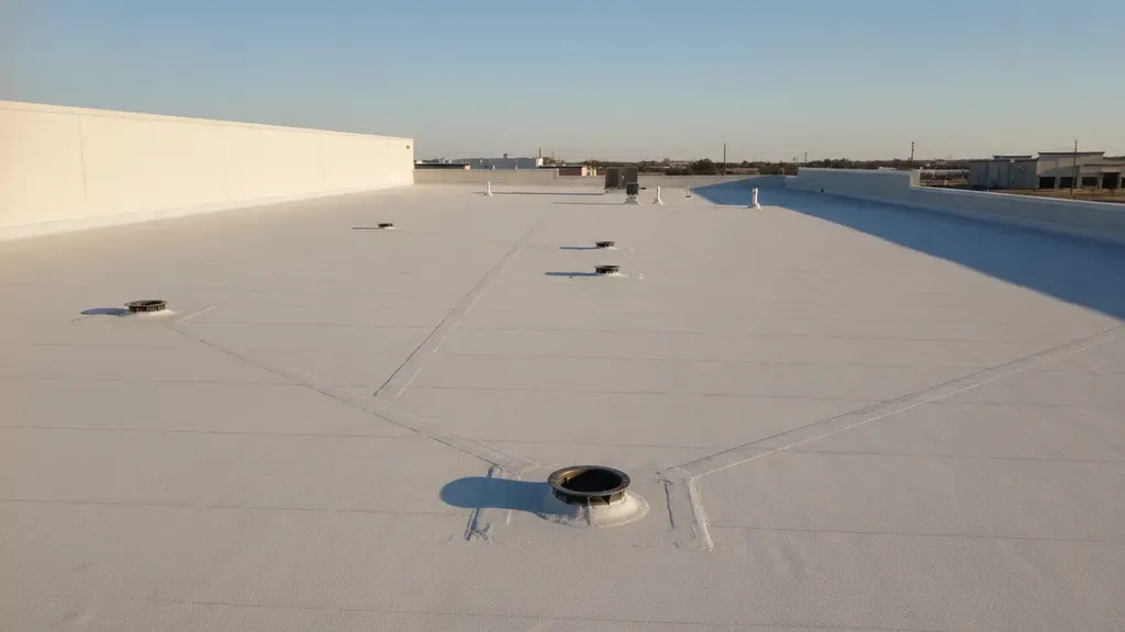 Commercial low-slope roof with visible drains and finished membrane details