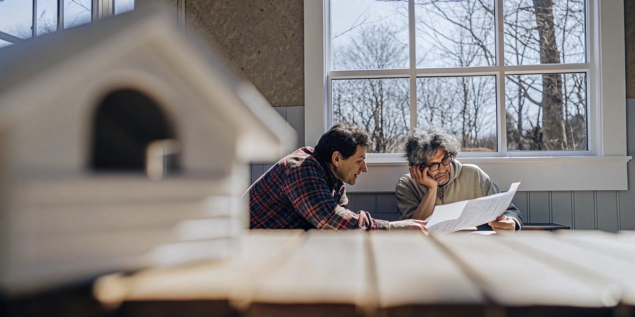 Texas homeowner reviewing roofing contract paperwork with a contractor at home