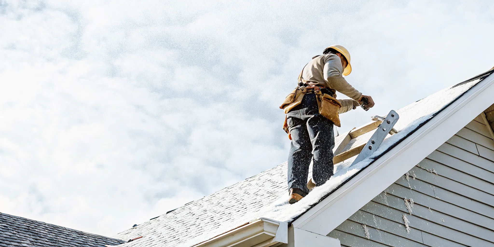 Professional roofer inspecting a Texas asphalt shingle roof after a storm