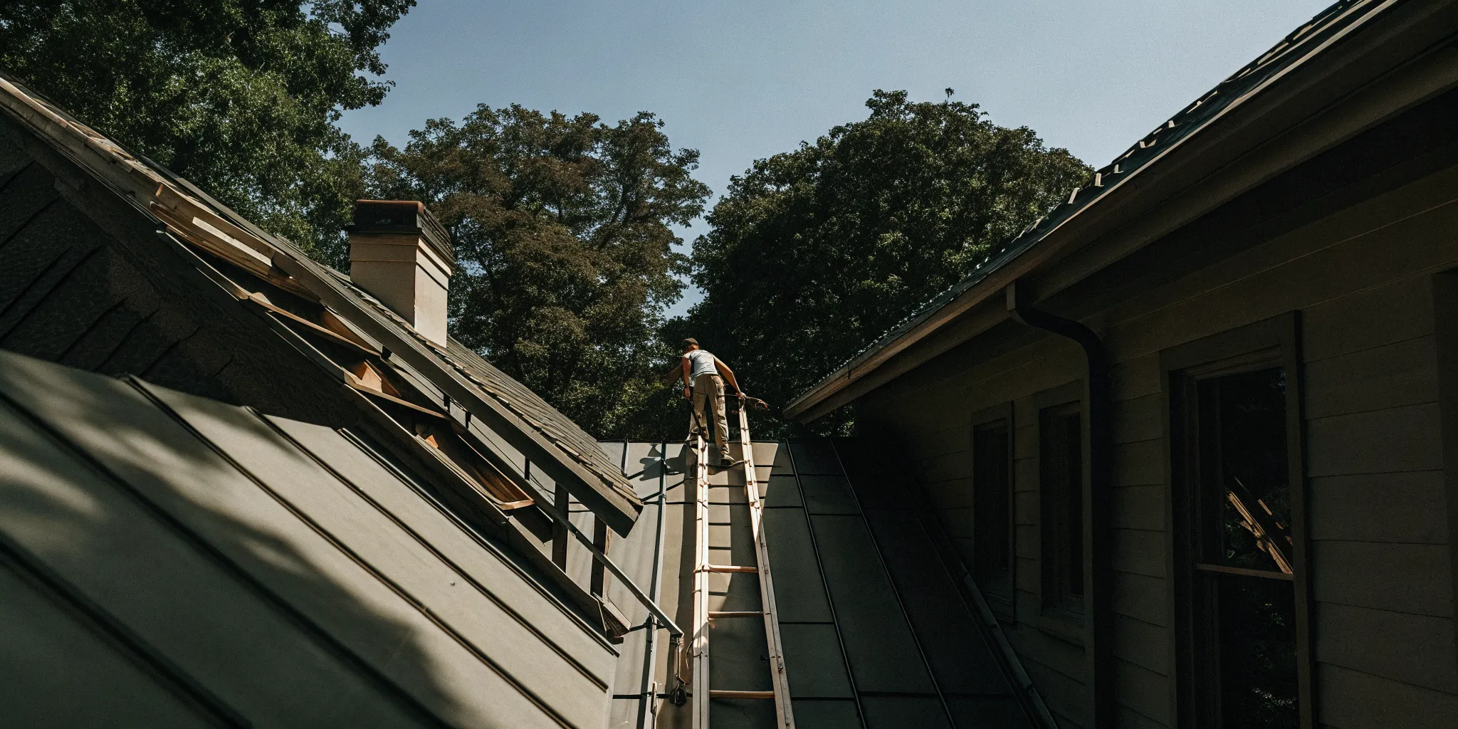 Roofing crew installing standing seam metal panels on a Texas home