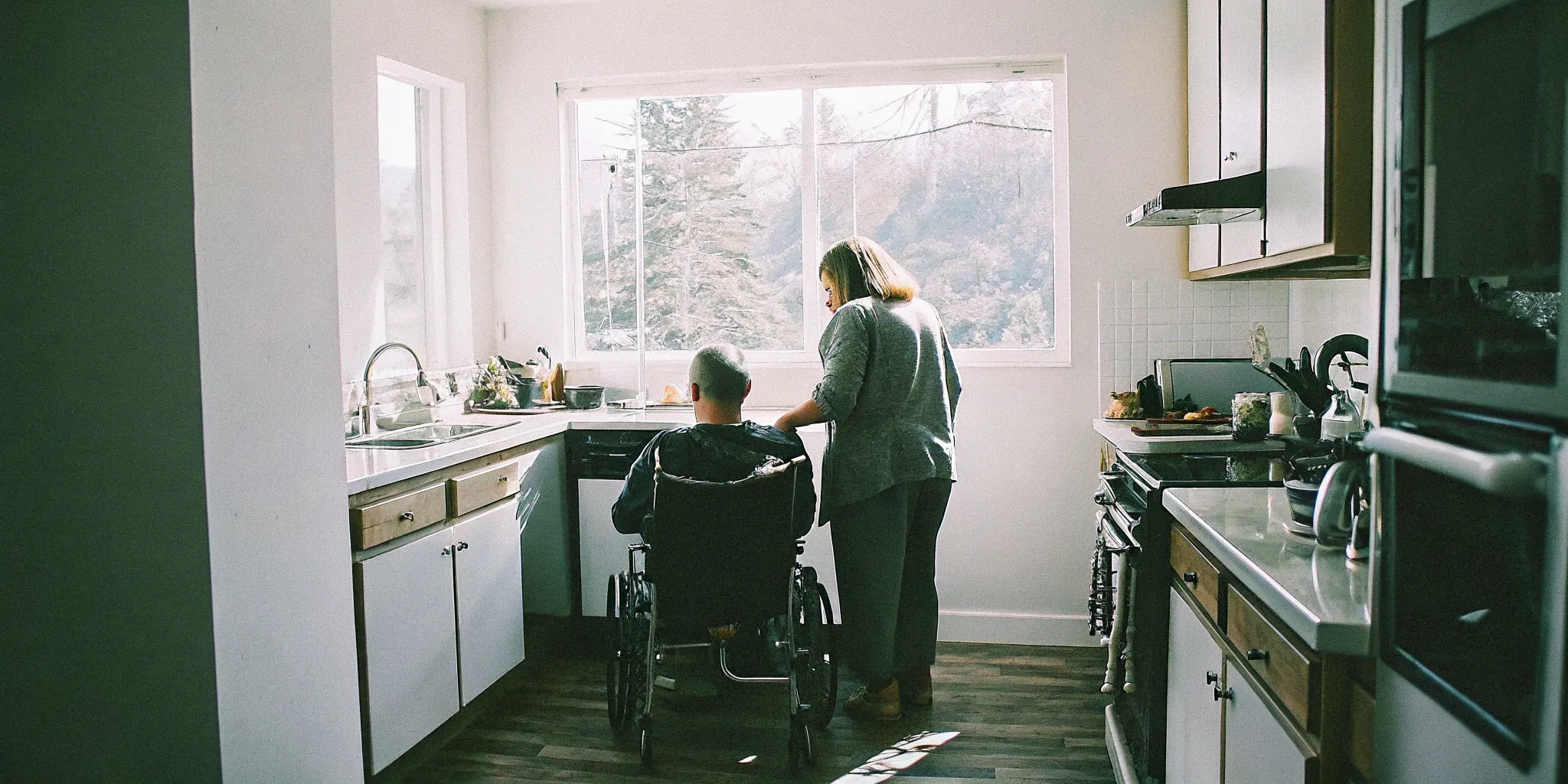 Adult and caregiver preparing a meal together at home