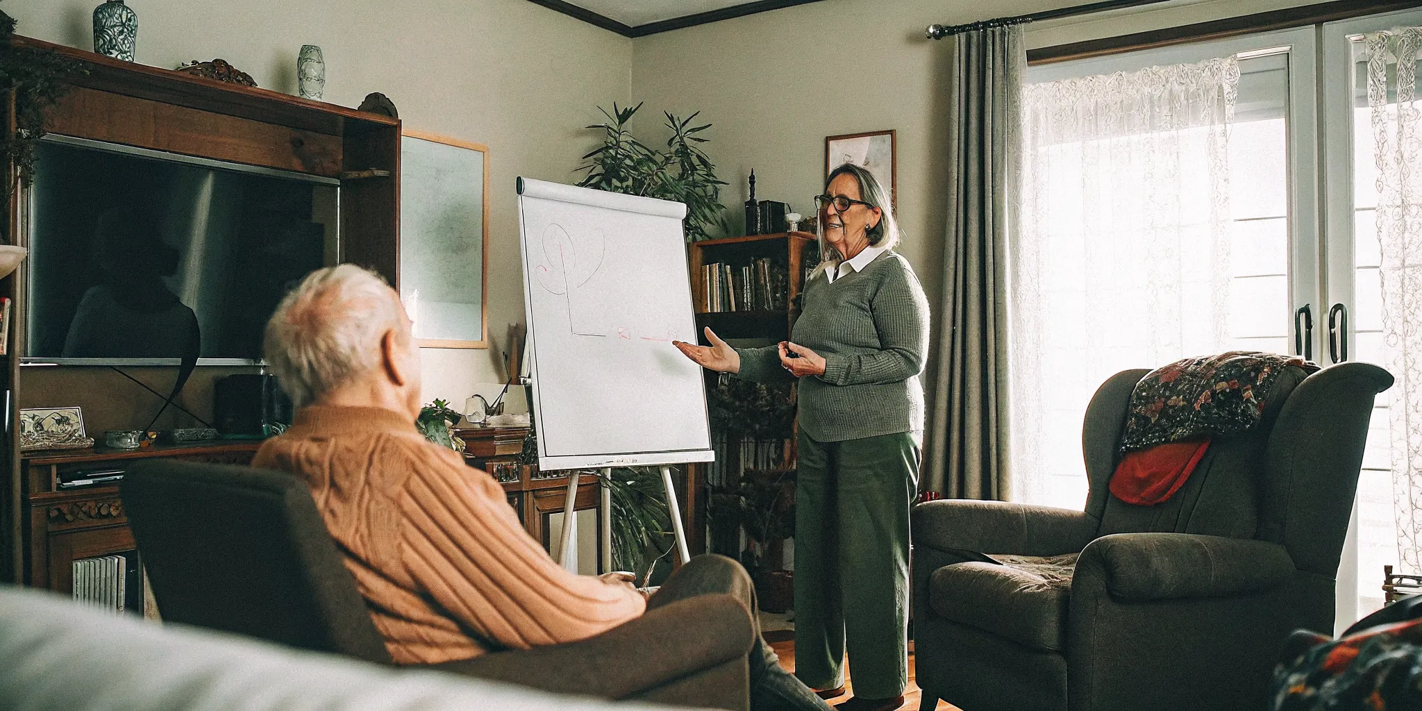 Registered Nurse reviewing personalized care plan with a senior's caregiver