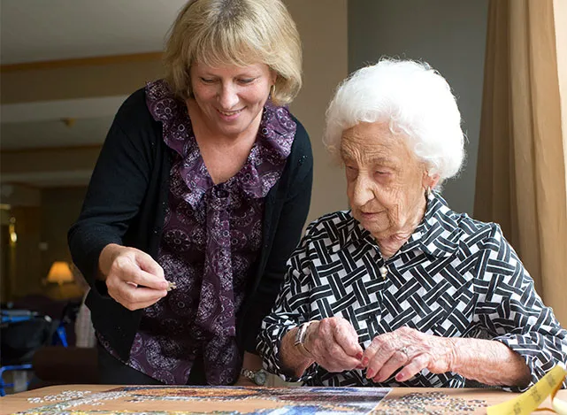 Professional caregiver providing companionship to an older adult