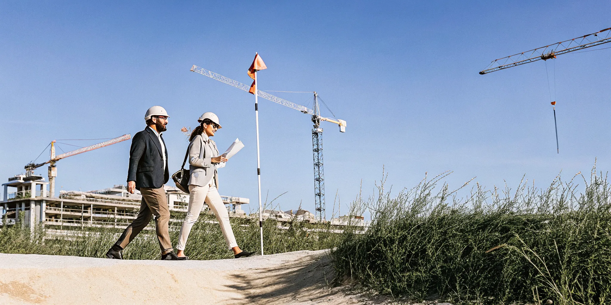 Executives and advisors walking a greenfield industrial site during a property tax site selection review
