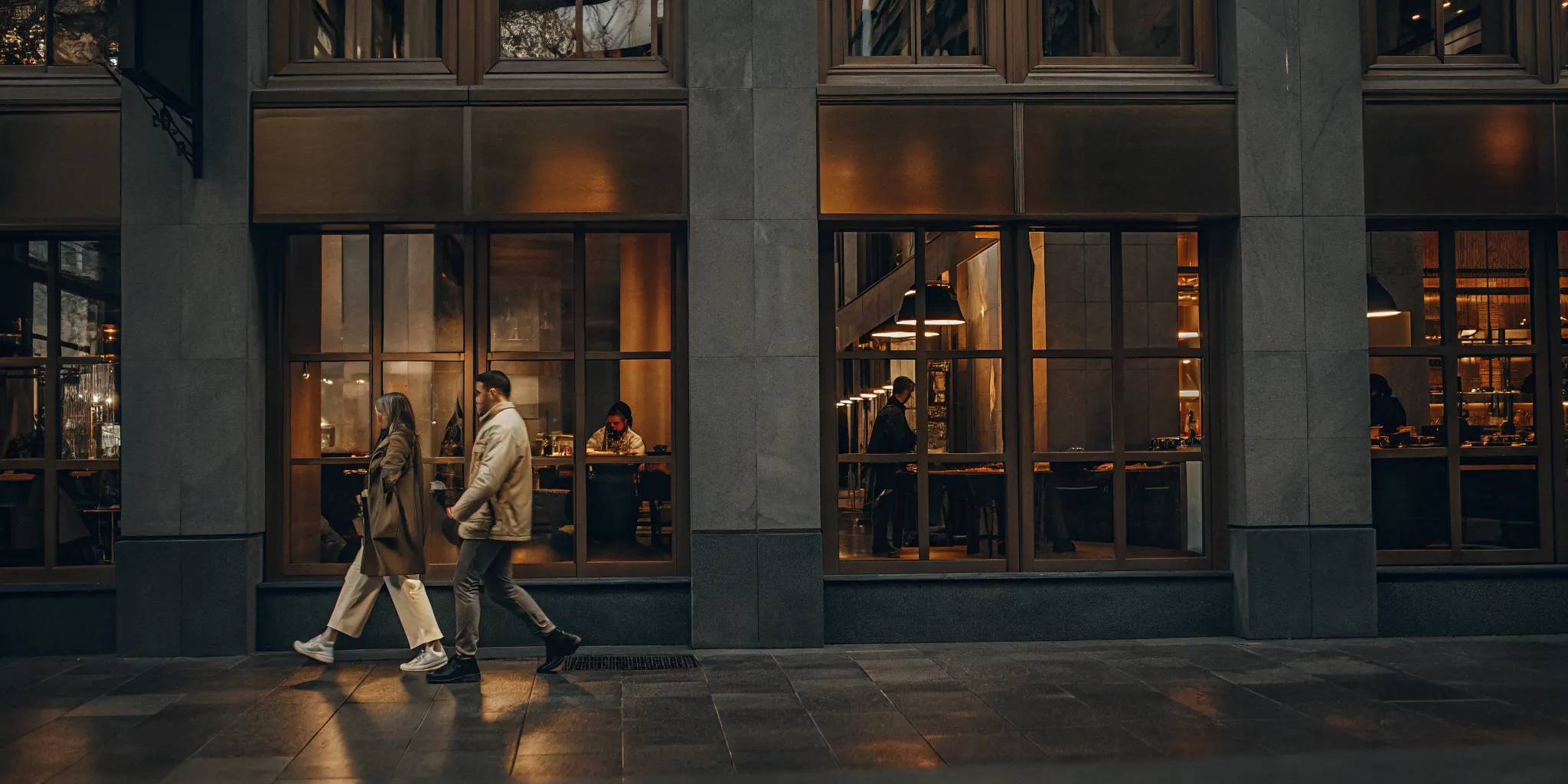 A modern mixed-use property showing vibrant retail spaces on the ground floor with apartment levels above.