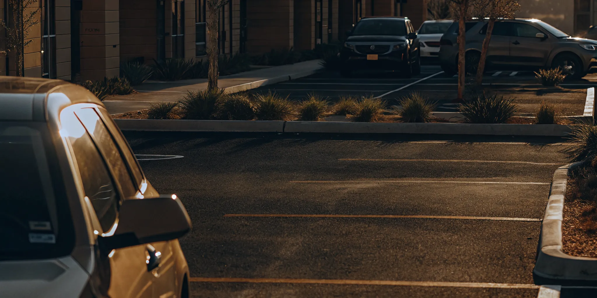Well-maintained student housing parking lot with clear signage and landscaping