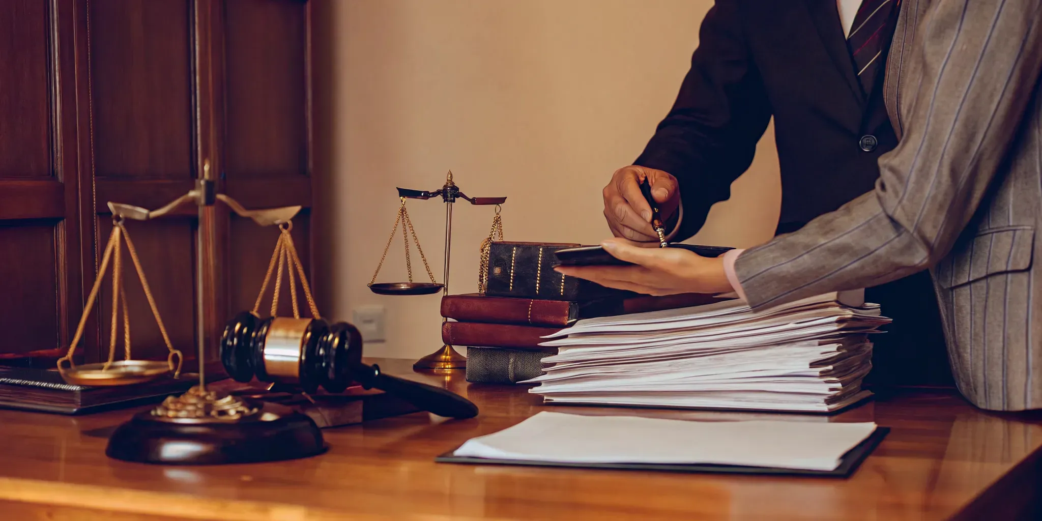 Law office desk with legal documents, calculator, and clock representing a settlement delay waiting period