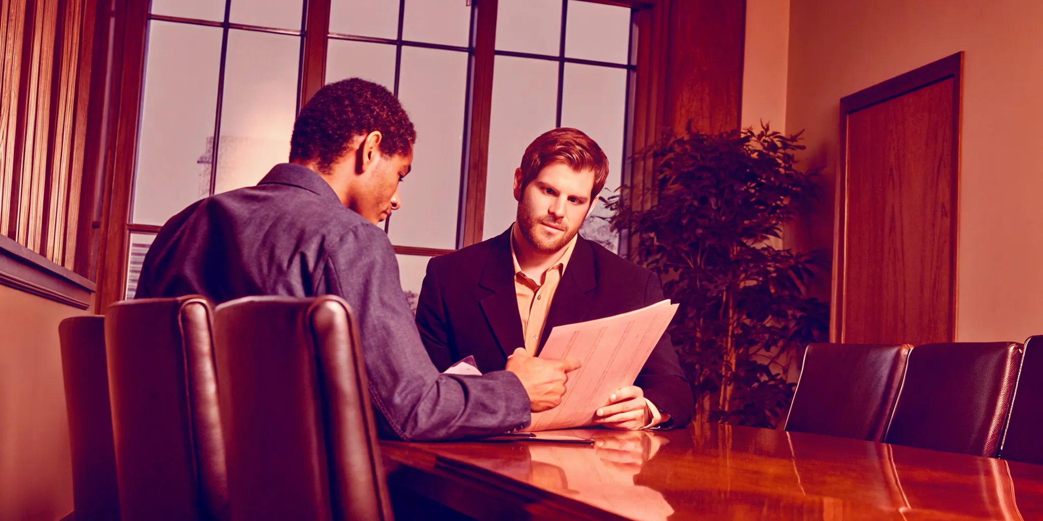 Pennsylvania attorney reviewing litigation funding documents with a client at a conference table