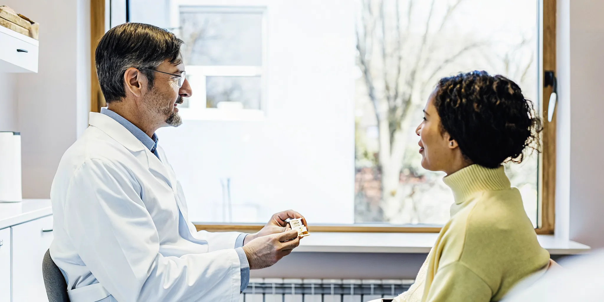 Dentist explaining All-on-X implant treatment during a consultation