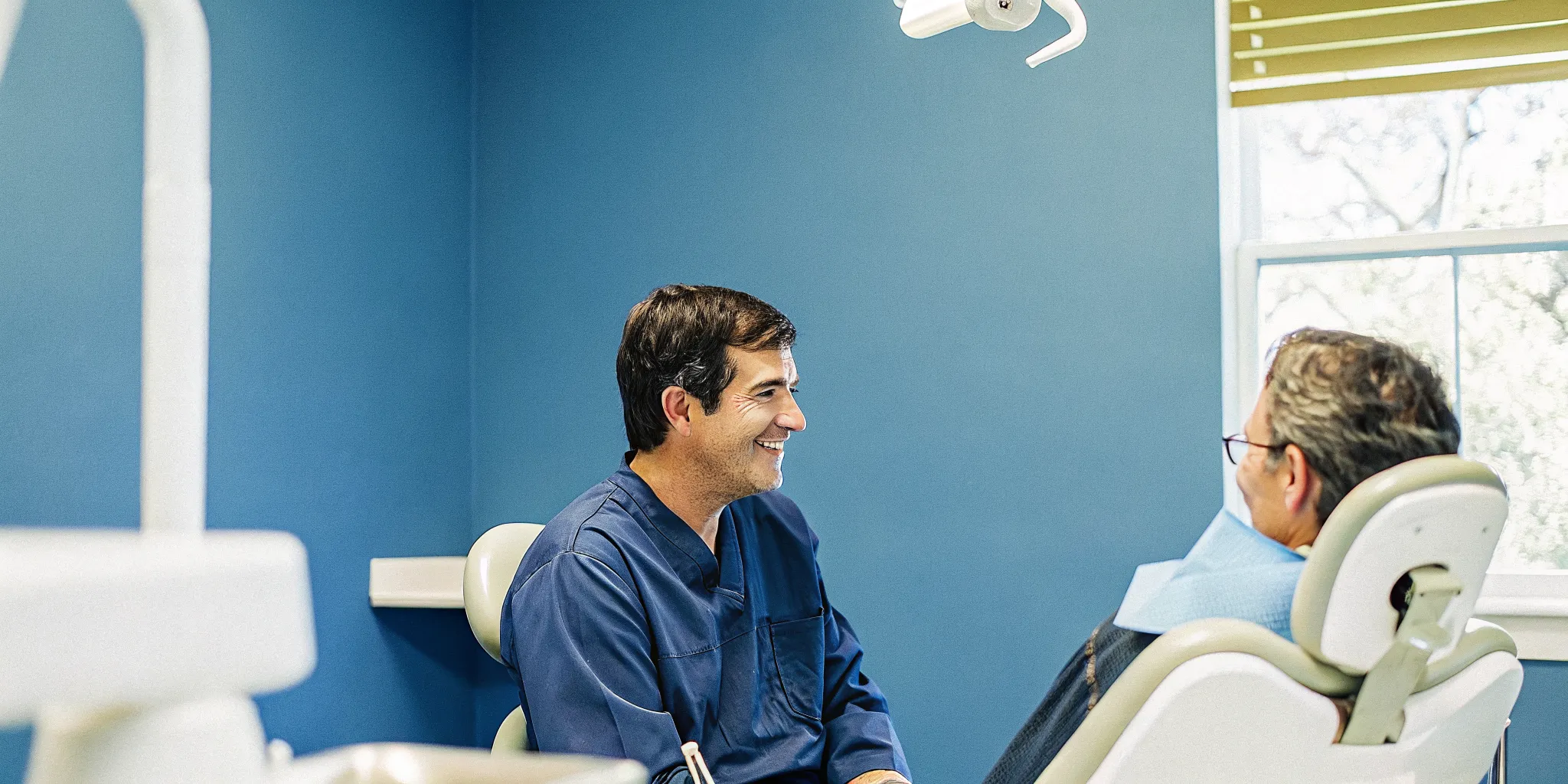 Dentist discussing the oral health and overall health connection with a patient
