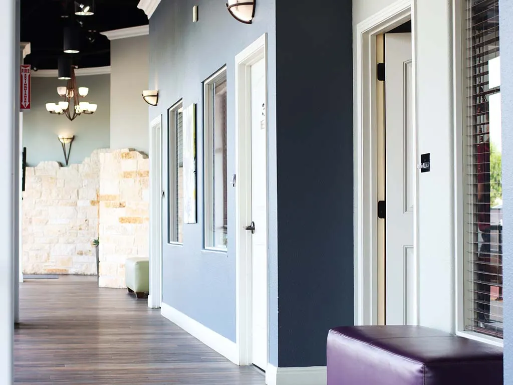 Modern salon suite hallway at a Salons by JC location supporting the semi-absentee Concierge Manager model
